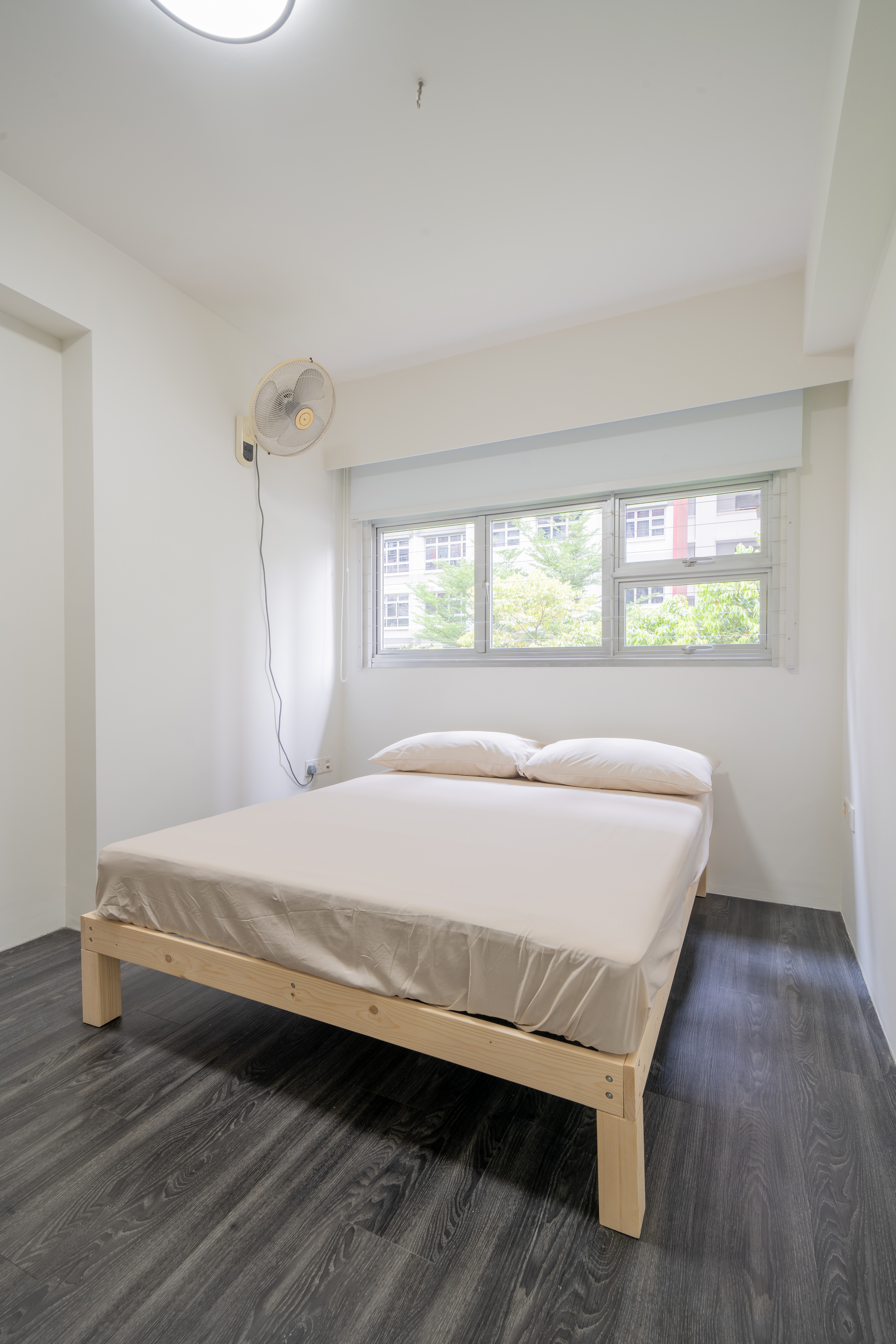 Minimalist Home With A Bright Airy Feel - Modern minimalist bedroom, white walls, large window, wooden floor, dark wood