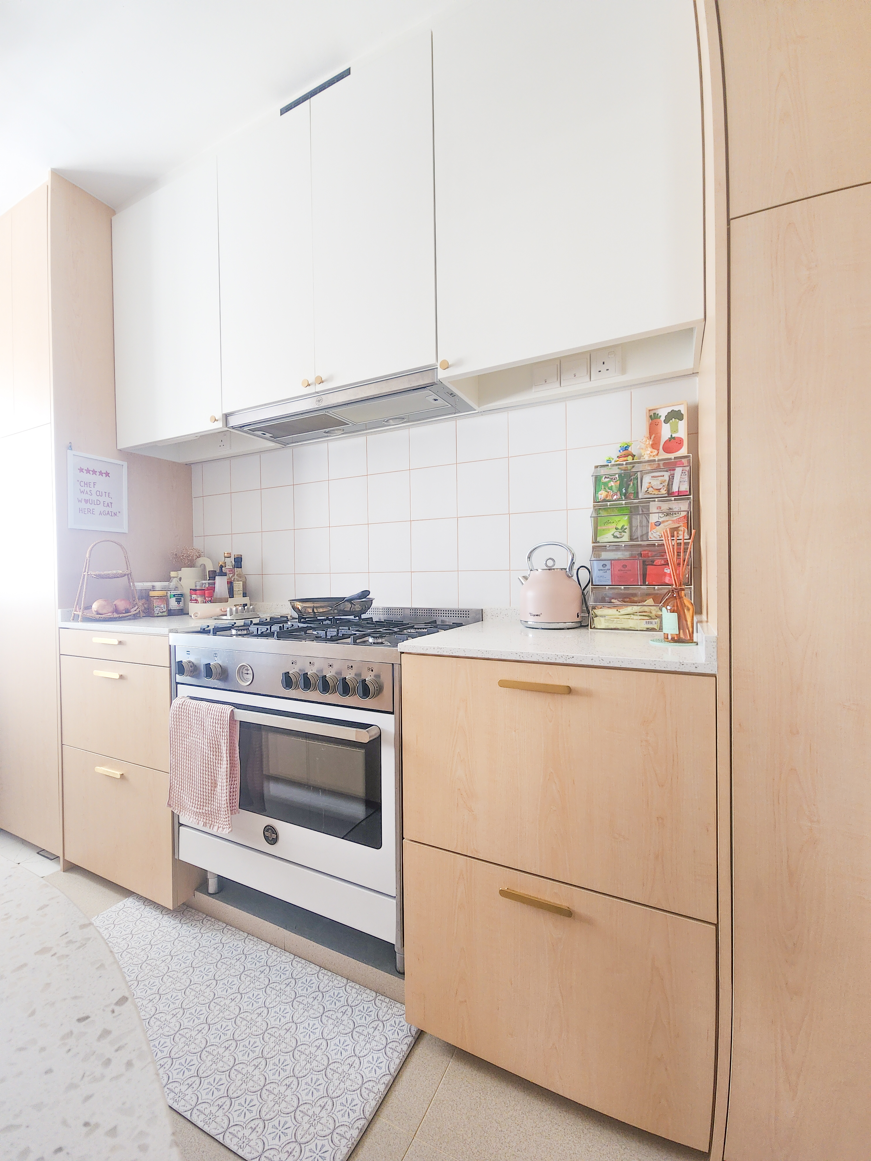Step inside a chef's kitchen - closed concept, functional & aesthetic - Light beige kitchen cabinets, white tiled backsplash