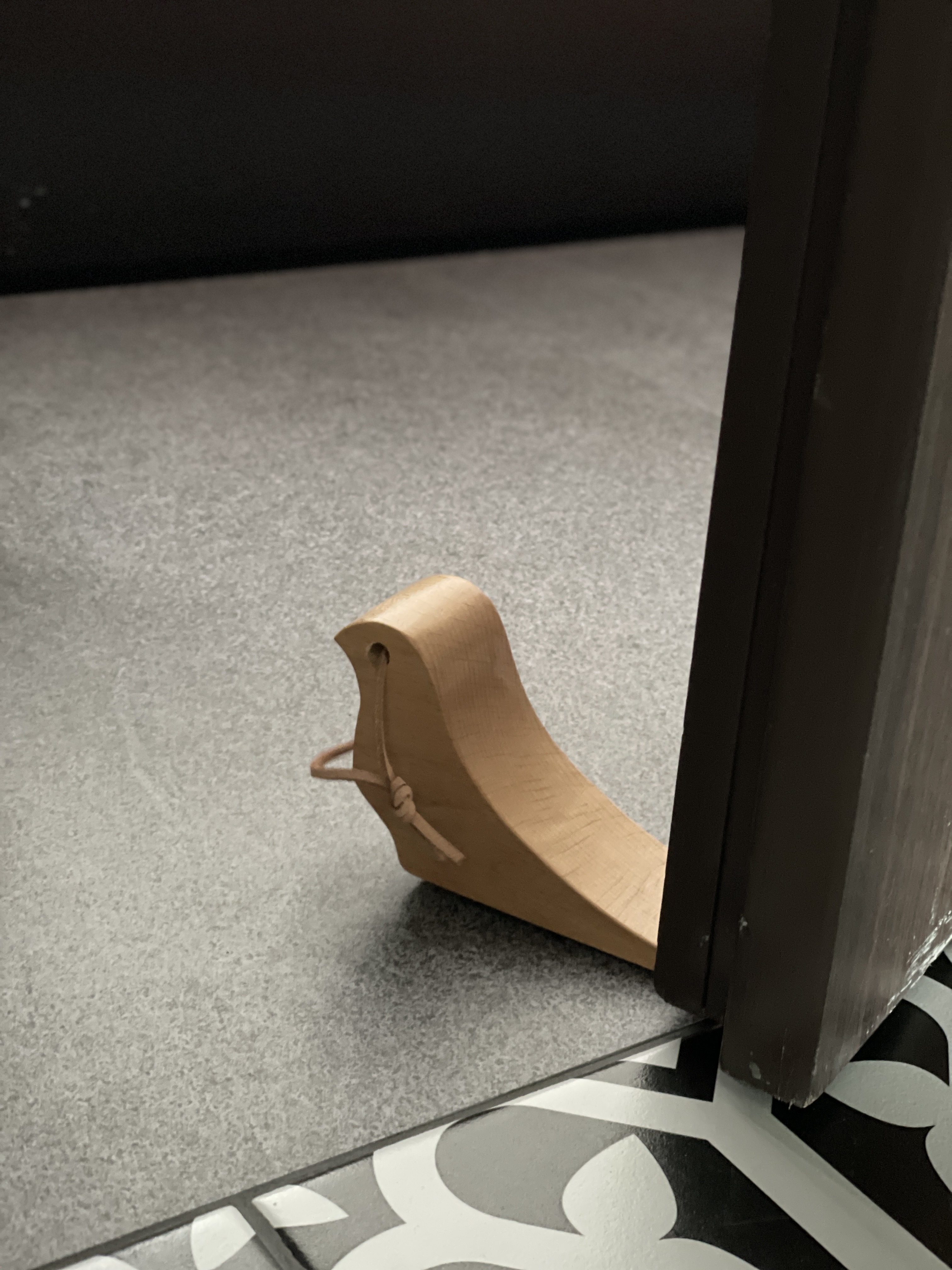 Entryway: A dark, moody space Decompression Chamber - Wooden slide, black and white patterned floor, indoor setting, small
