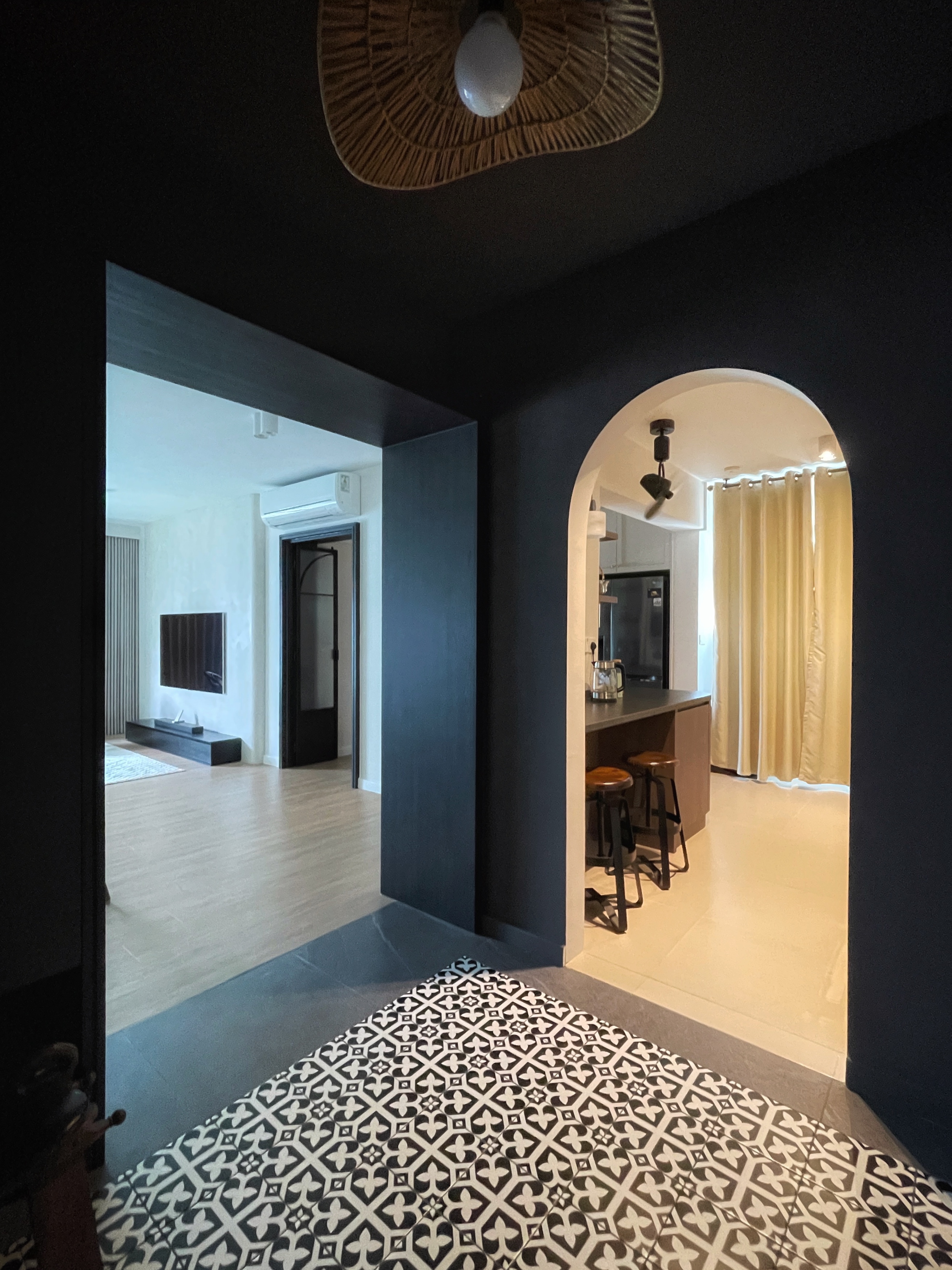 Entryway: A dark, moody space Decompression Chamber - Modern minimalist interior, dark walls, open doorway, living room