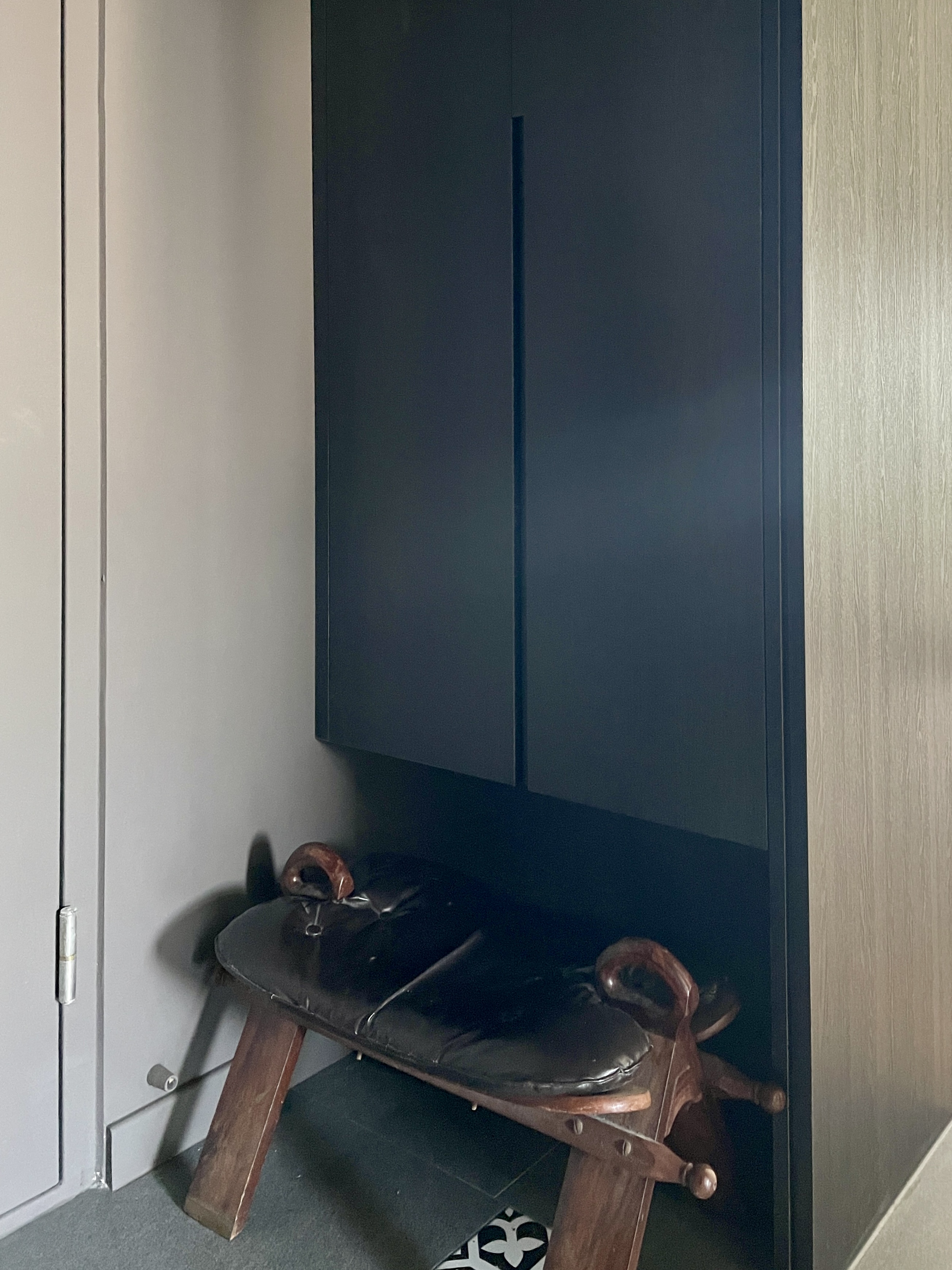 Entryway: A dark, moody space Decompression Chamber - Wooden bench, dark wooden frame, cushioned seat, rustic design, antique