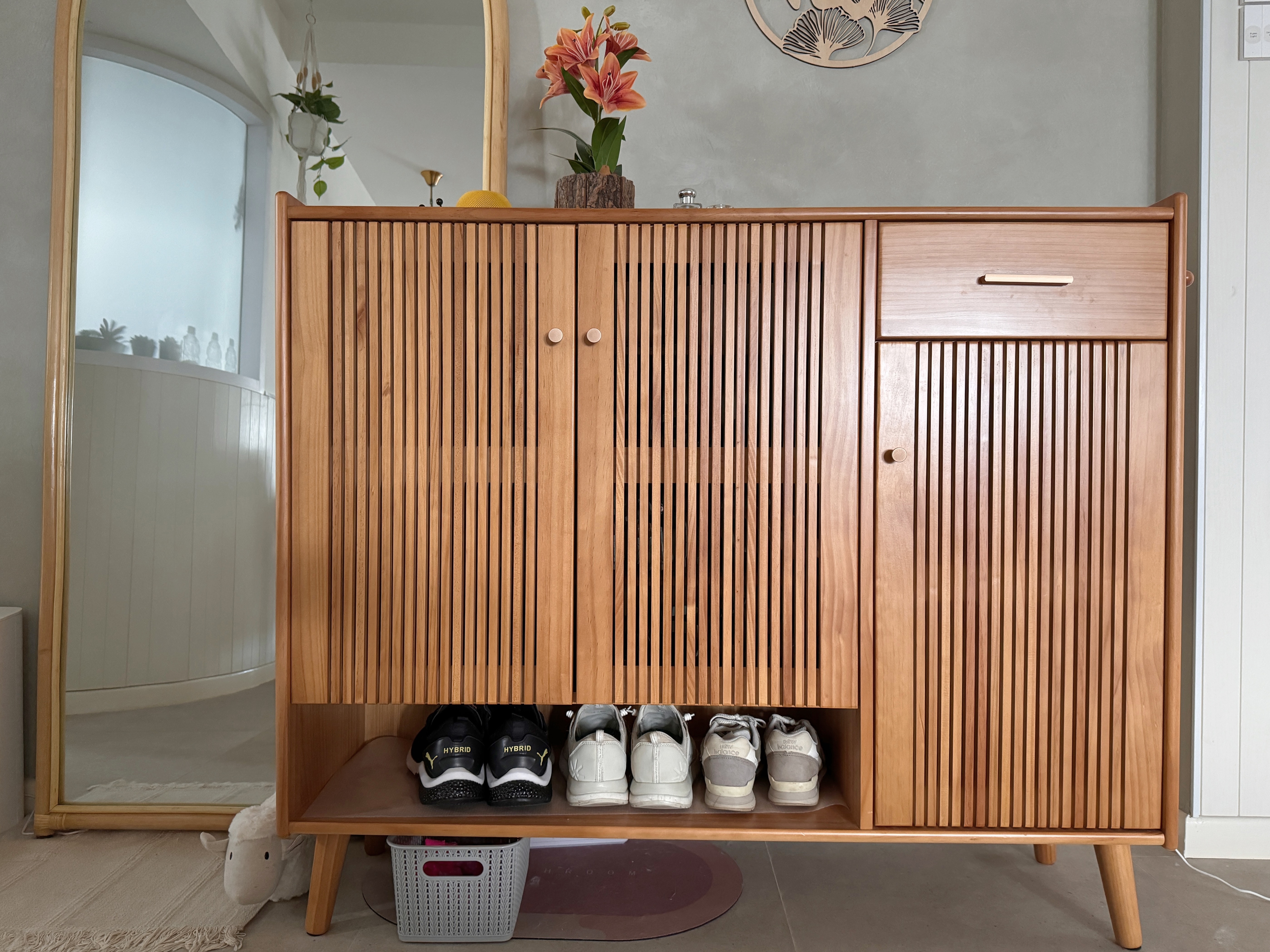 Earthy Entryway with Pops of Color: Ditching the built-in shoe cabinet - Wooden cabinet with vertical slats, neatly organized