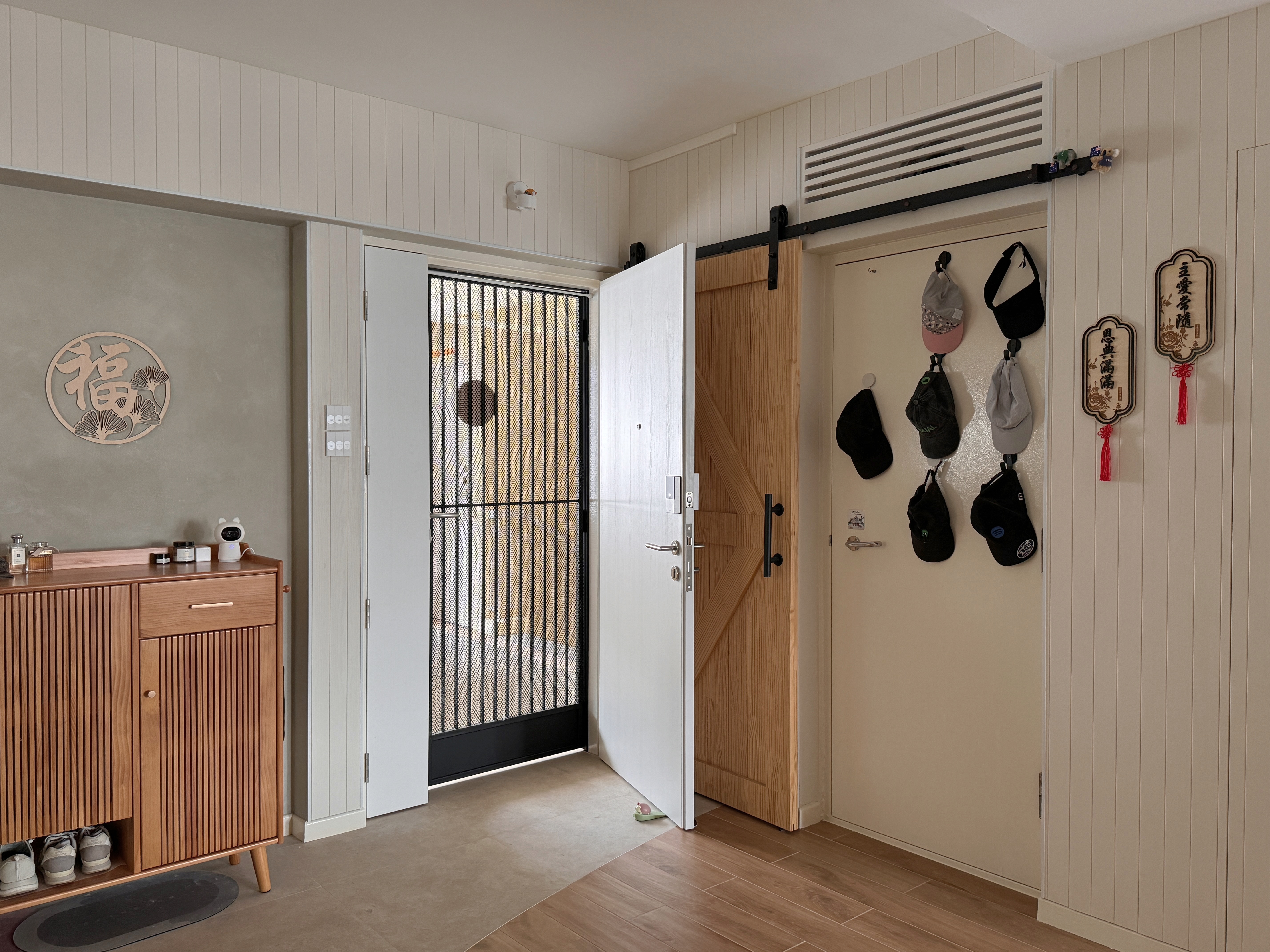 Earthy Entryway with Pops of Color: Ditching the built-in shoe cabinet - Wooden cabinet, white door, black metal gate, beige