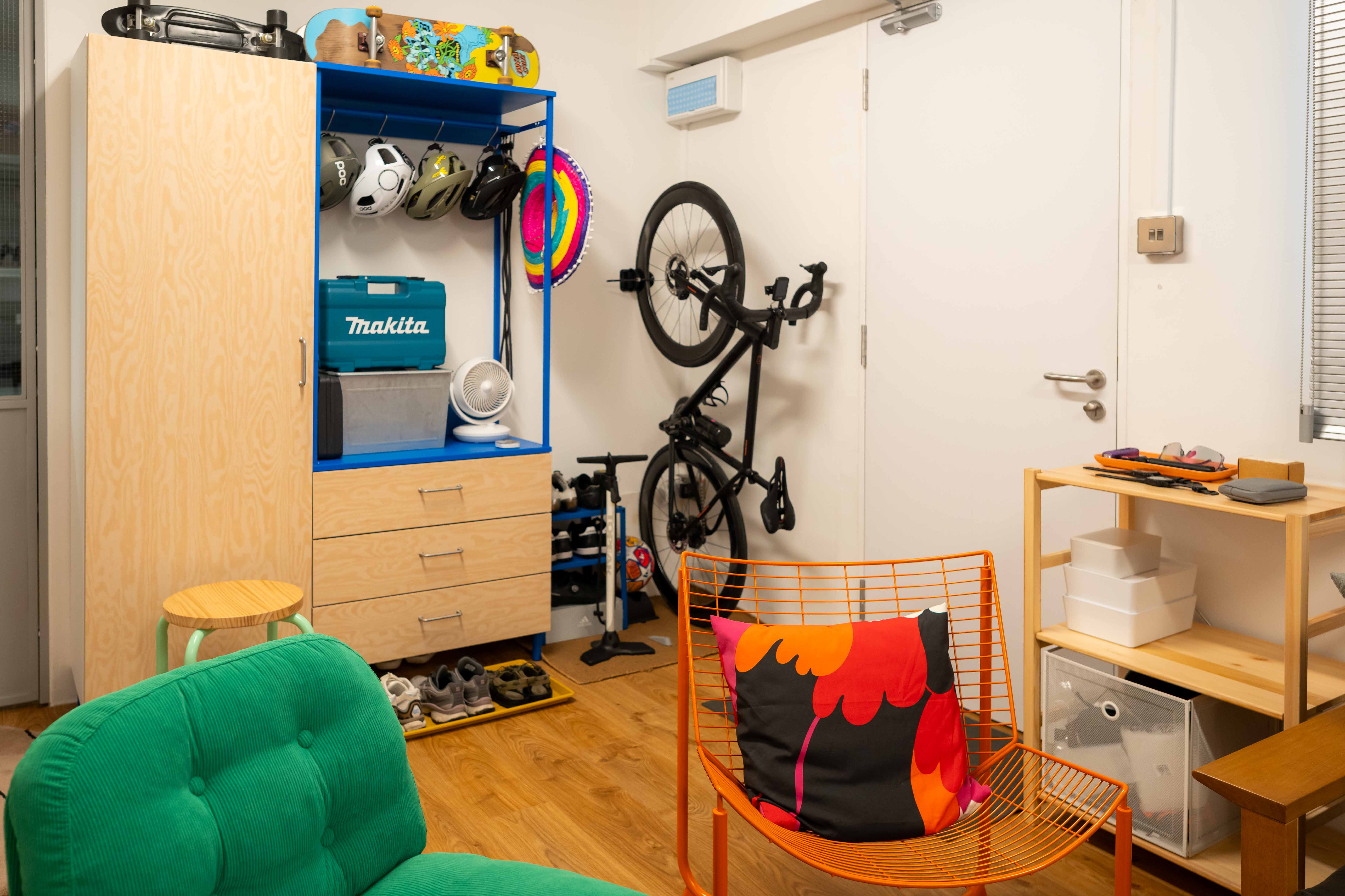 A colourful entryway with vibrant hues and a sporty vibe! - Wooden wardrobe, blue shelf, colorful helmet, black bicycle