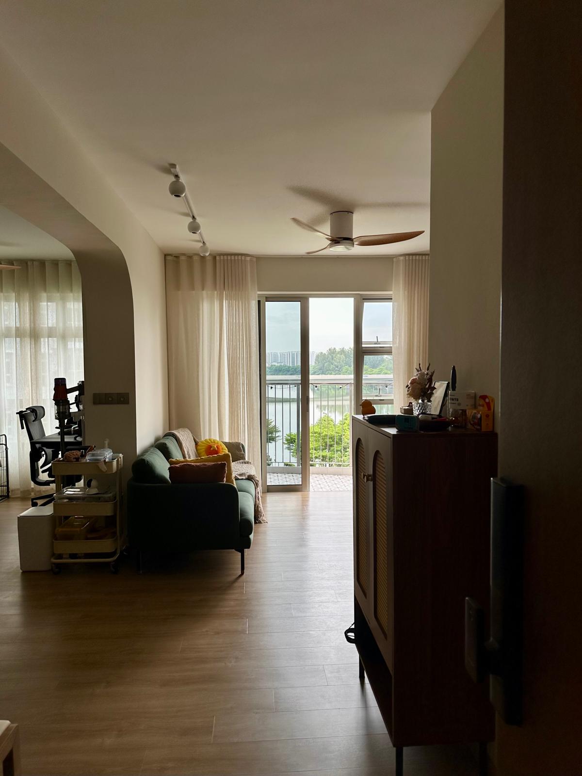 Our House-Hunting Journey: Finding 'the One' or Not? - Modern living room with green sofa, wooden floor, large windows with