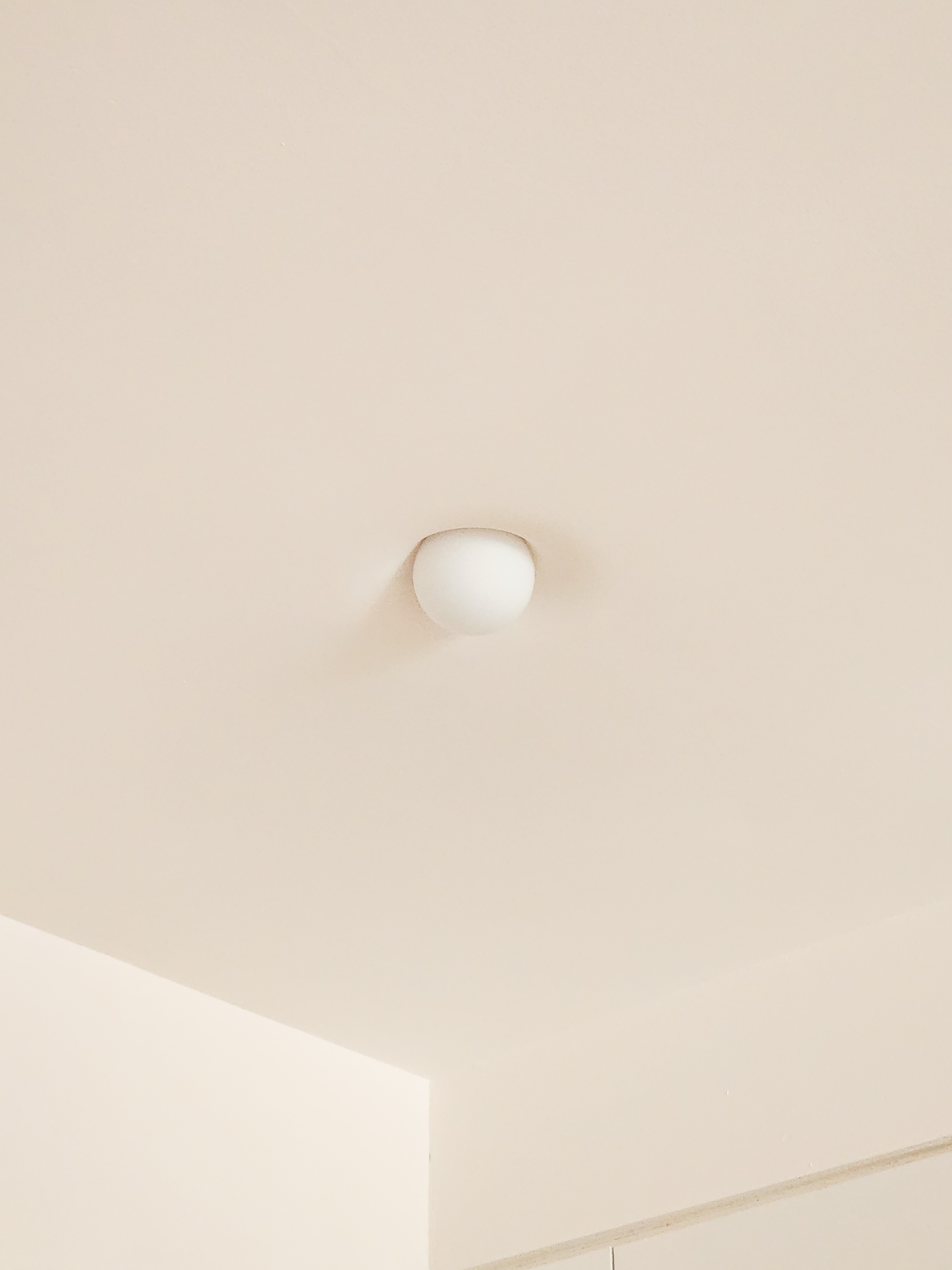 A Simple & Small Entryway Focused on Decor Without Built-Ins - Creamy beige ceiling, soft lighting, minimalist design, white