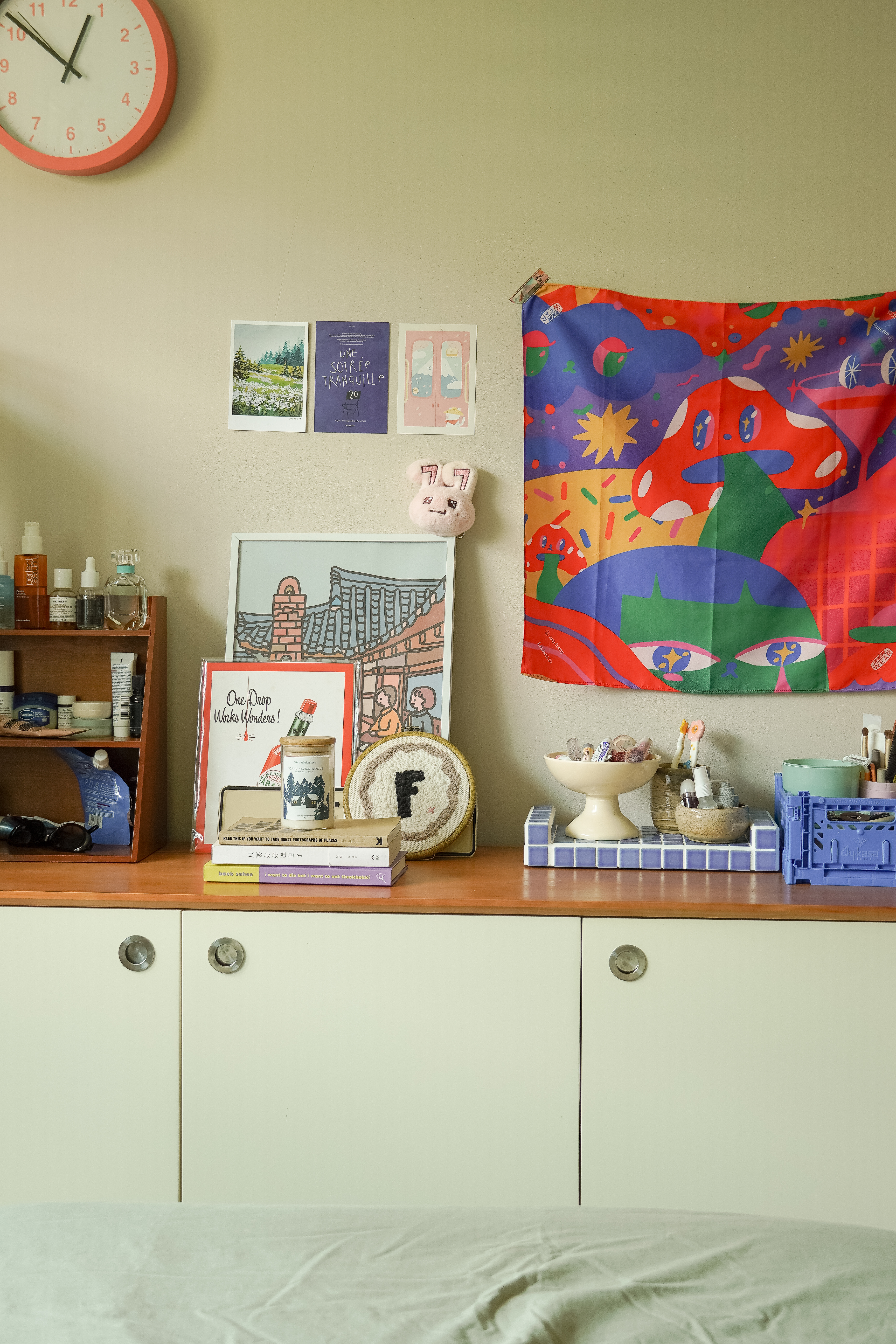 Get unready with me | A minimalistic bedroom entryway   - Wall clock, colorful tapestry, books, skincare products, framed