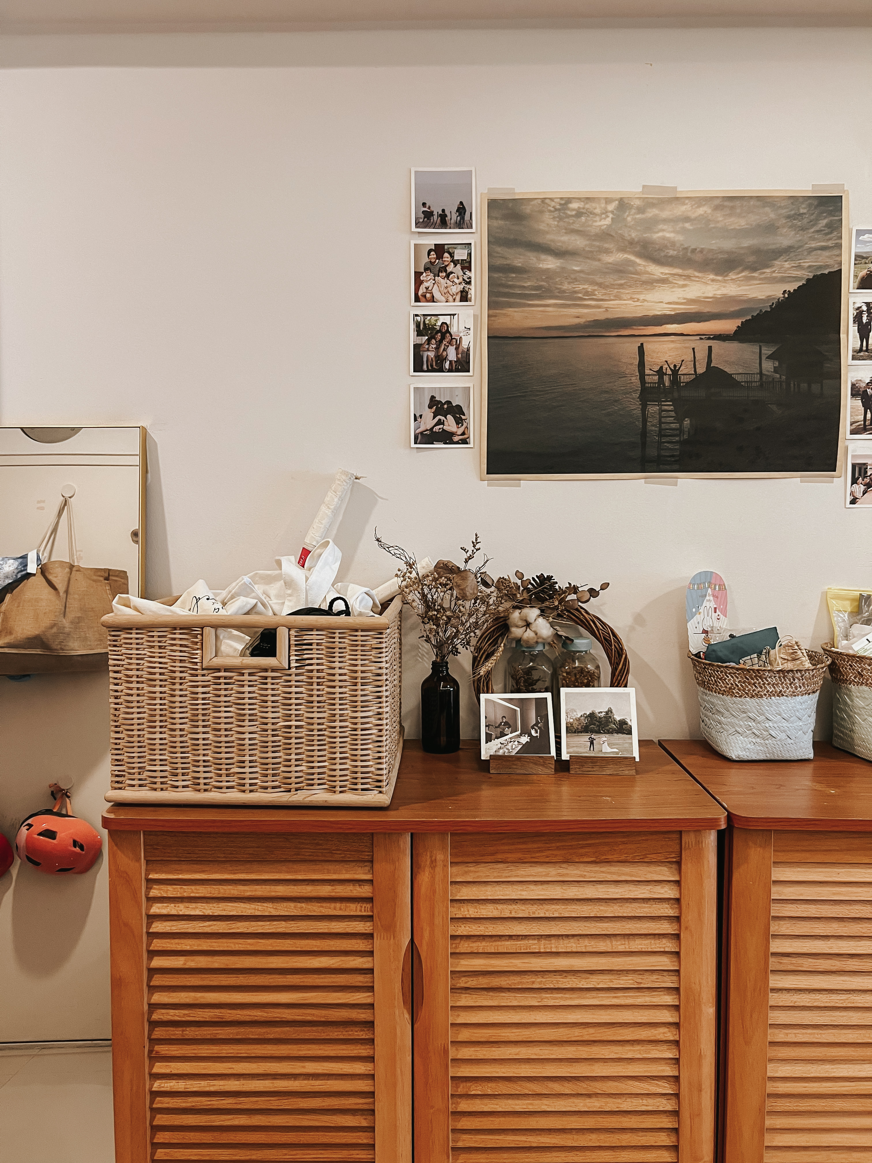 Our Entryway: A Practical Setup for Busy Families - Wooden cabinet, photo frames, black and white photos, wooden basket