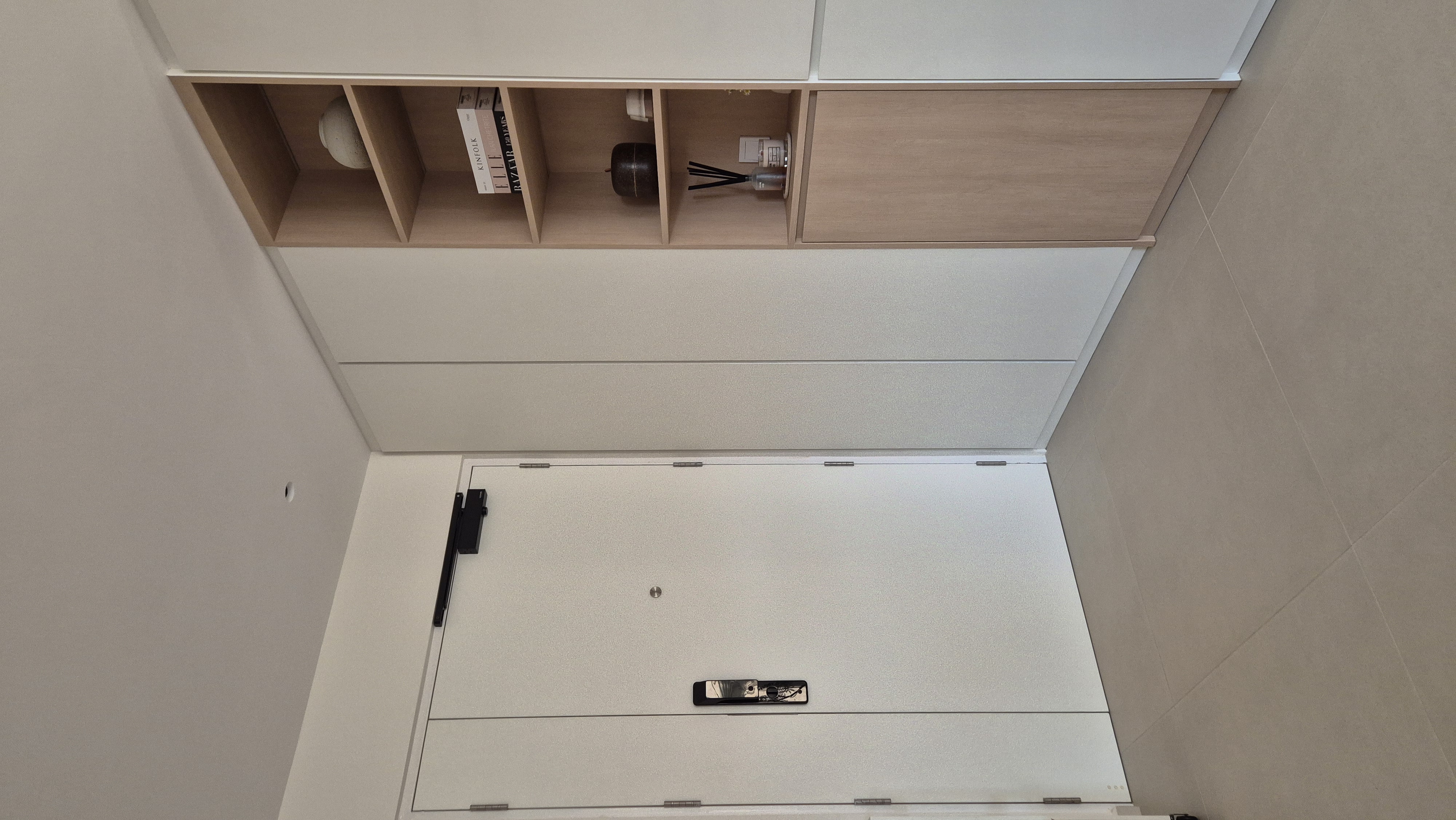 Our Entryway: Negative spaces abound - Wooden shelves, minimalist design, white cabinets, open shelving, books, decorative