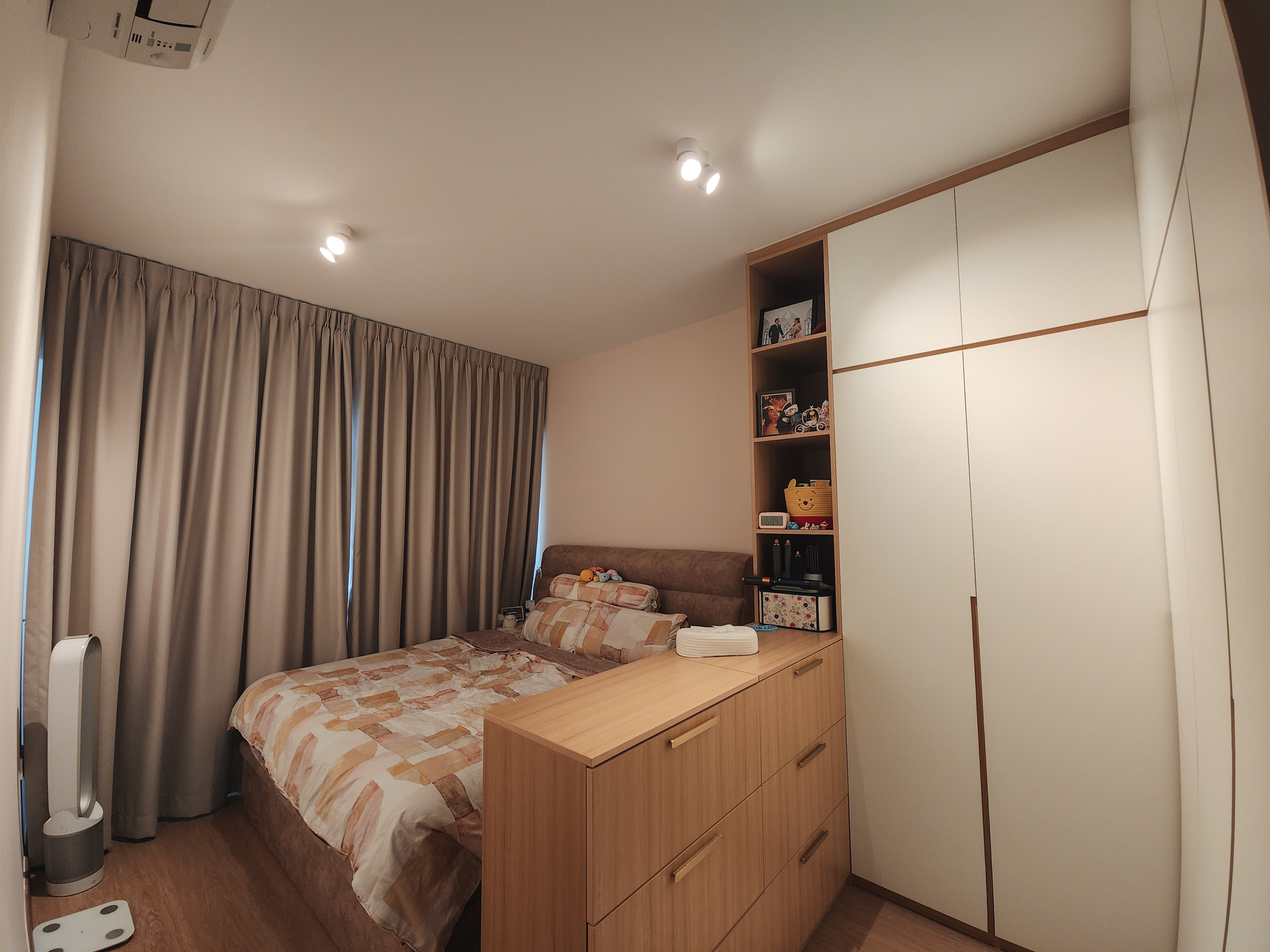 A cosy bedroom with warm neutral tones and a semi walk-in wardrobe