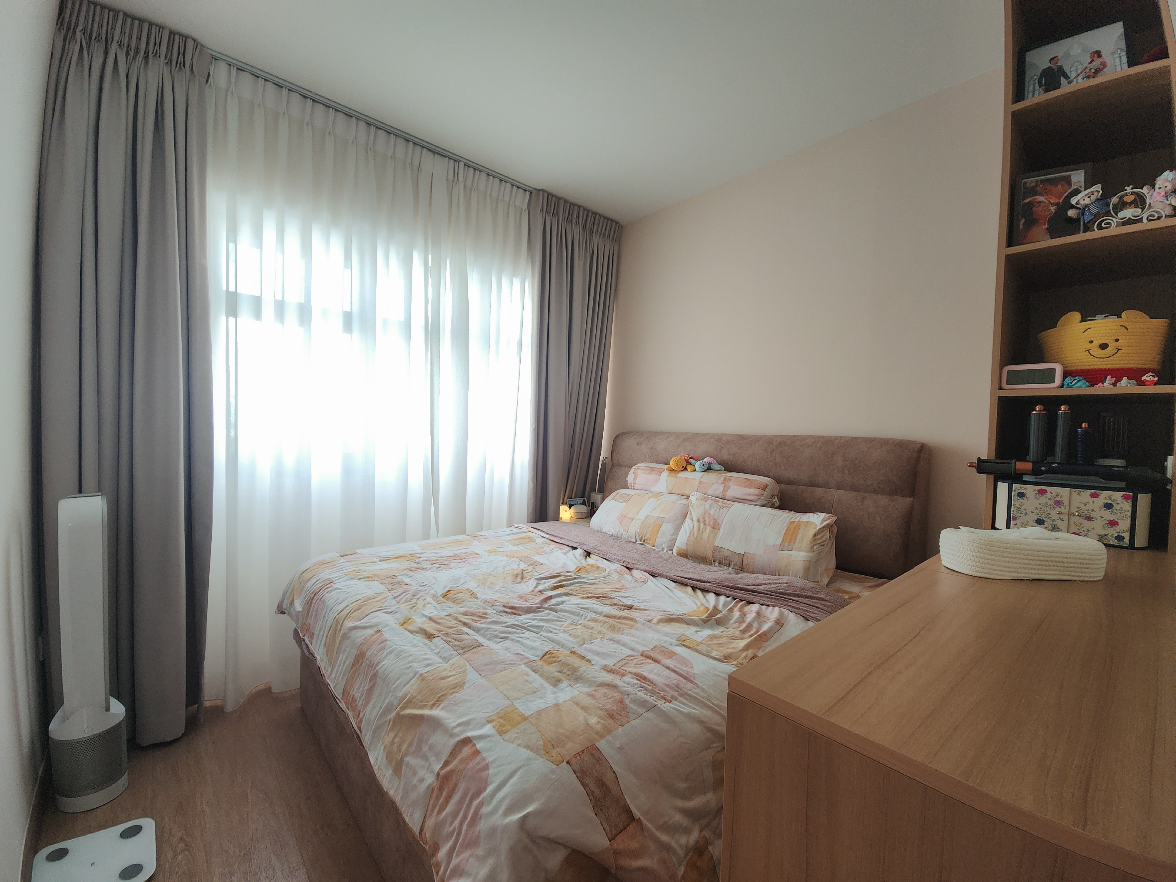 A cosy bedroom with warm neutral tones and a semi walk-in wardrobe
