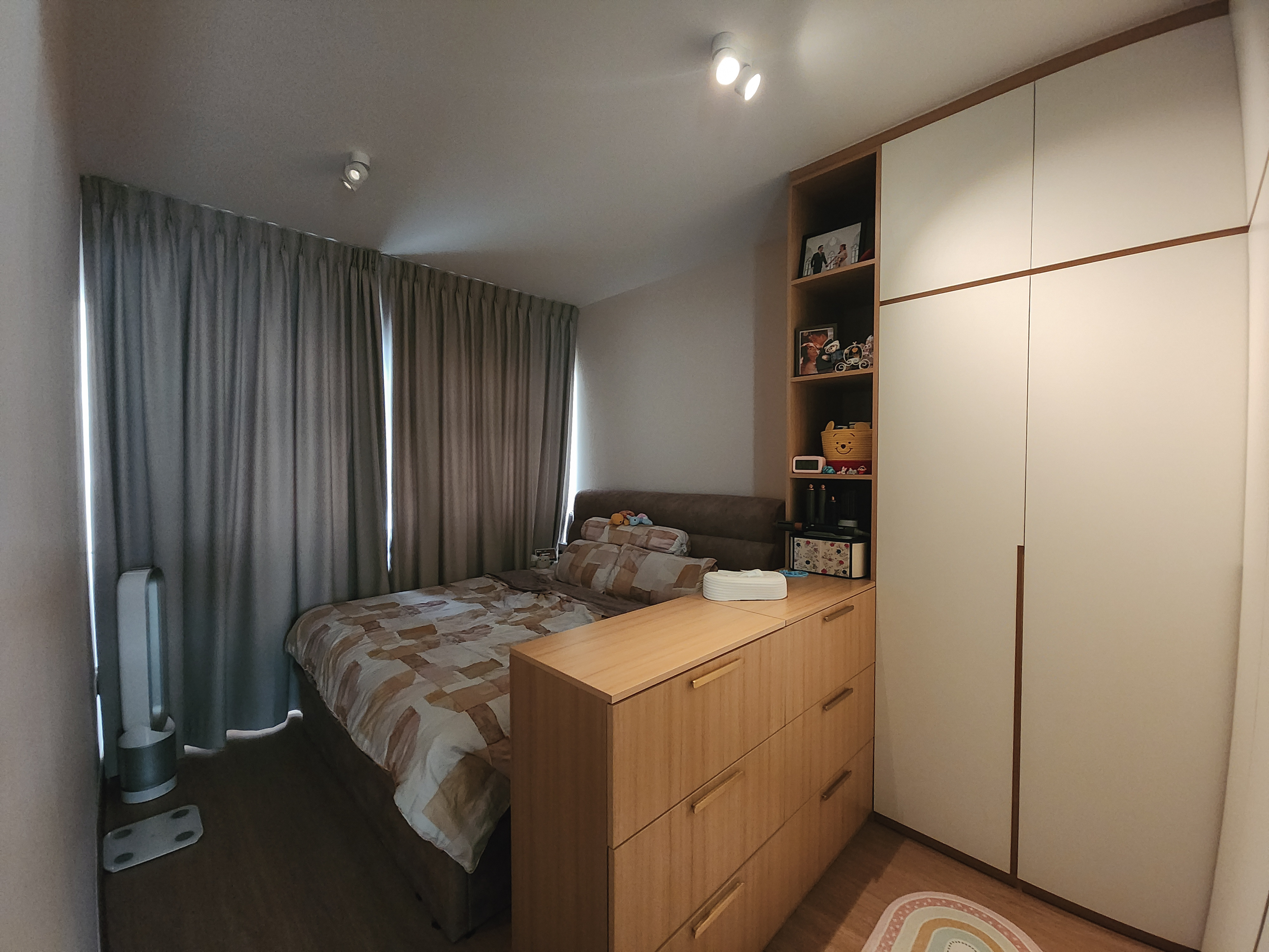 A cosy bedroom with warm neutral tones and a semi walk-in wardrobe