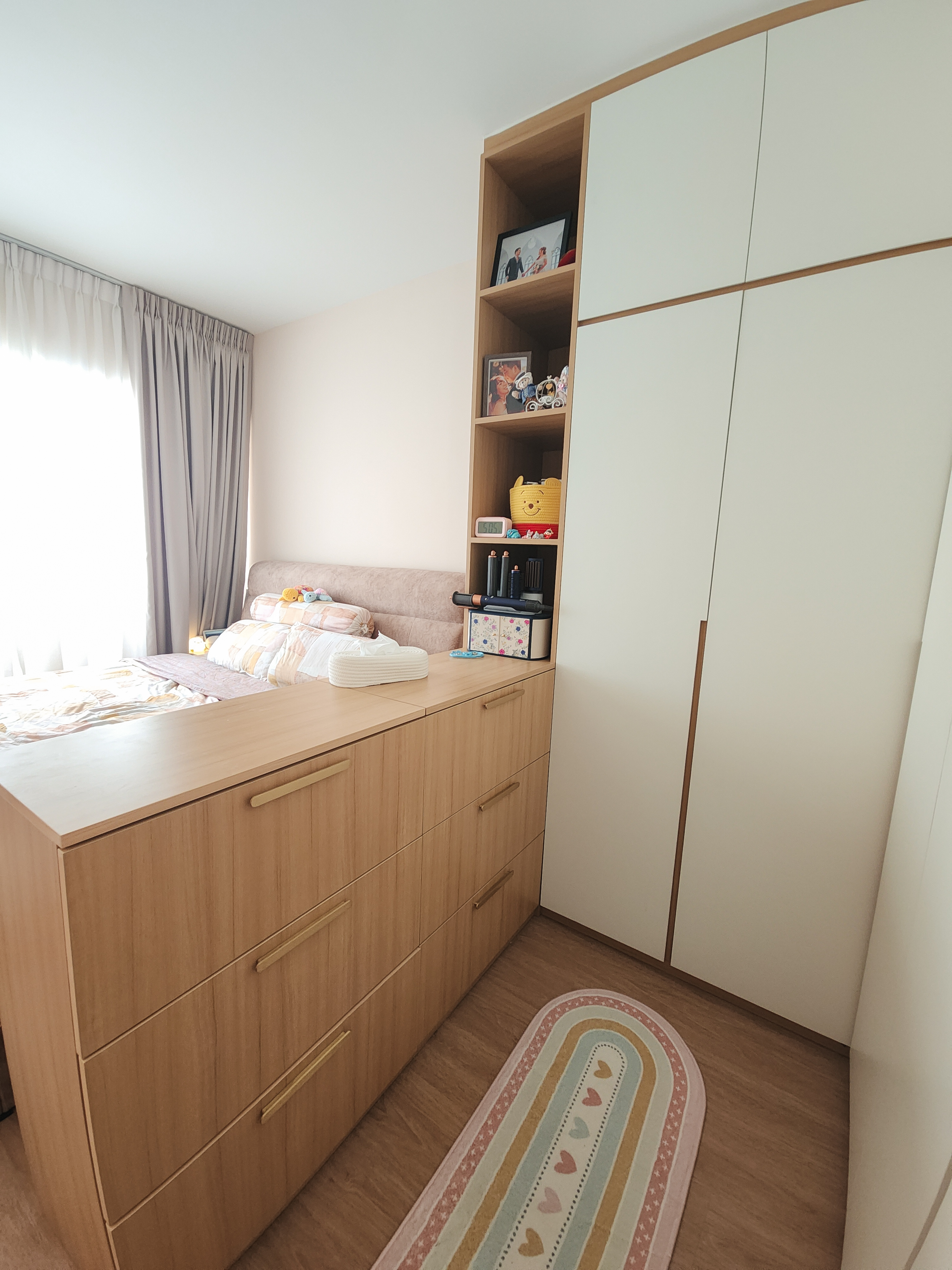 A cosy bedroom with warm neutral tones and a semi walk-in wardrobe