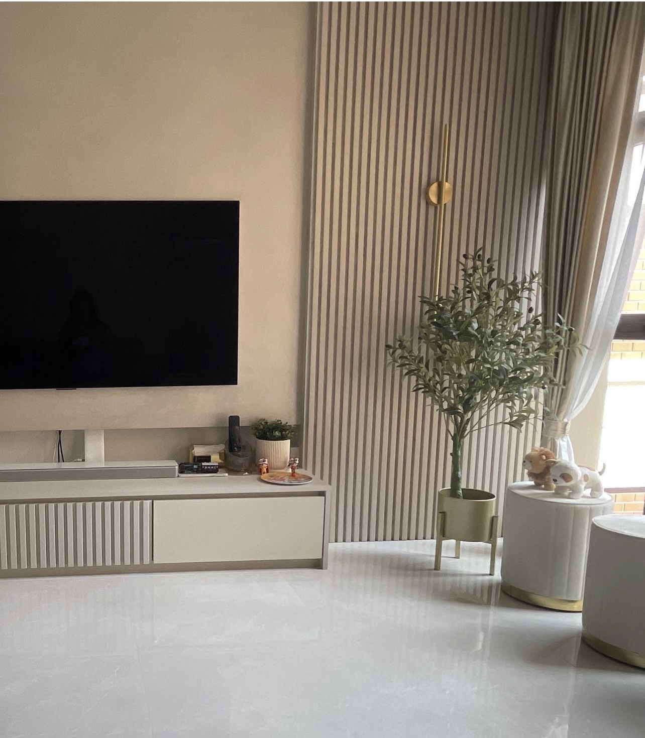Our modern living room with calm, neutral tones and fluted lines