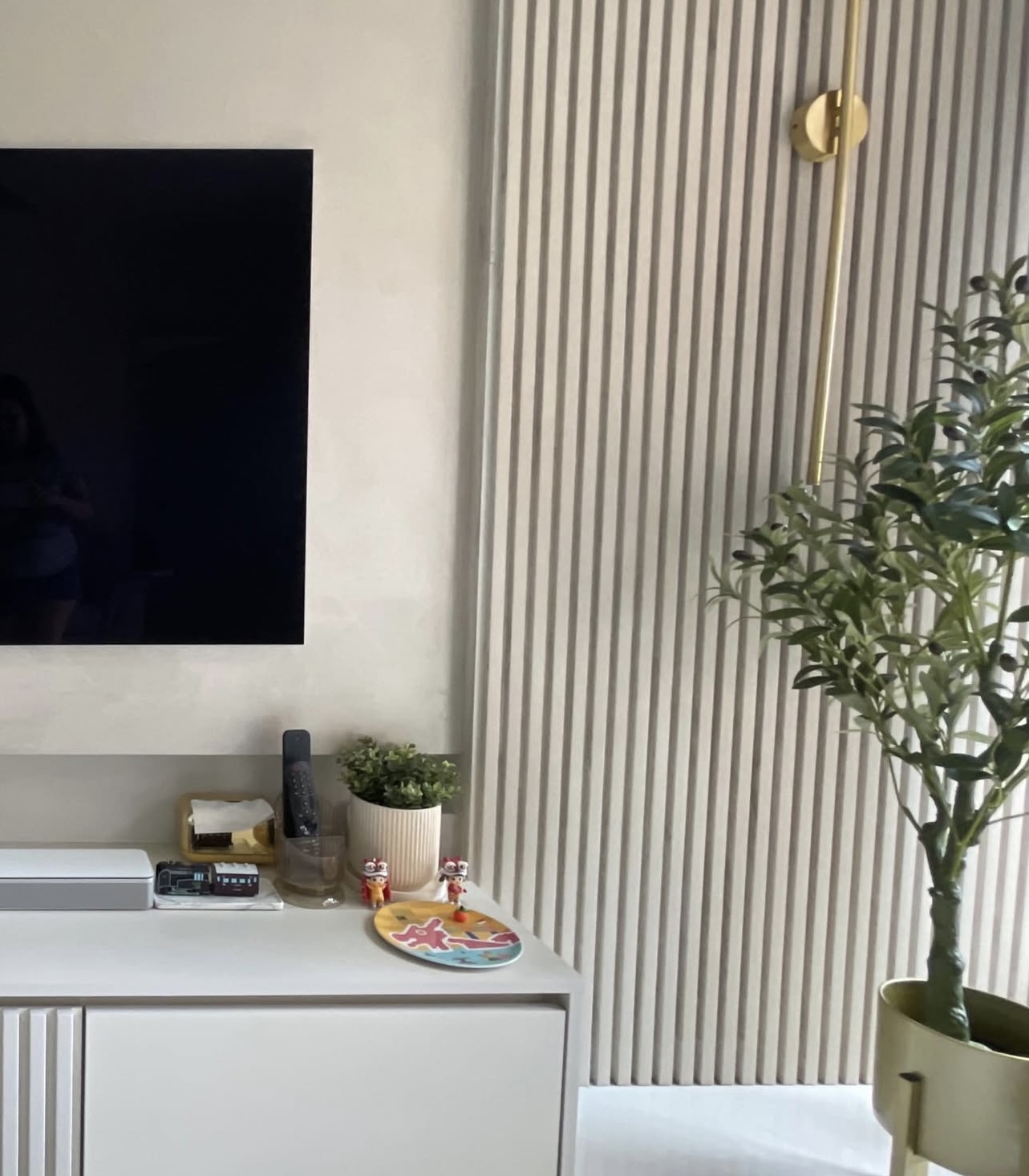 Our modern living room with calm, neutral tones and fluted lines