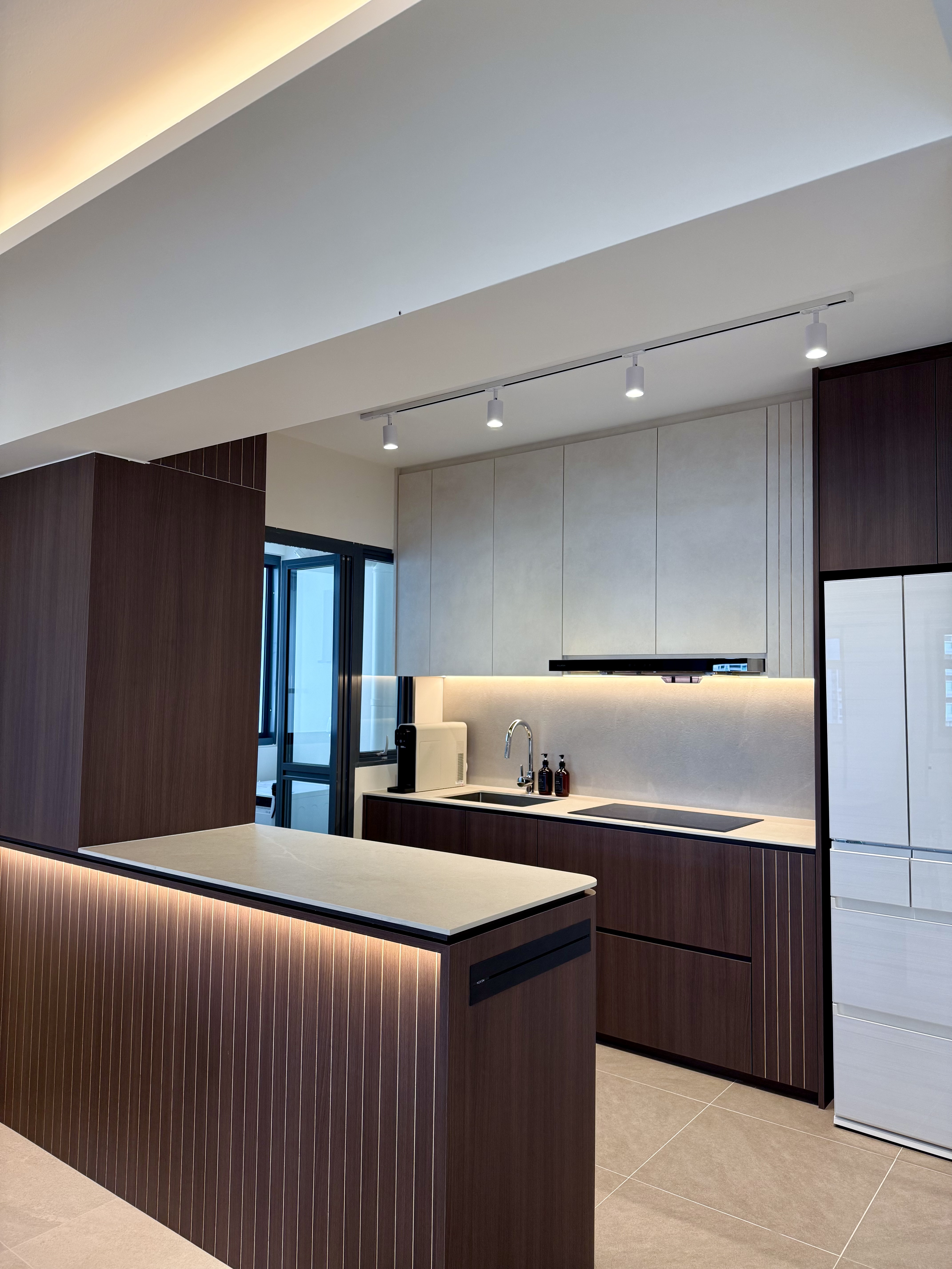 No walls, no distance — just a kitchen island at the center of it all