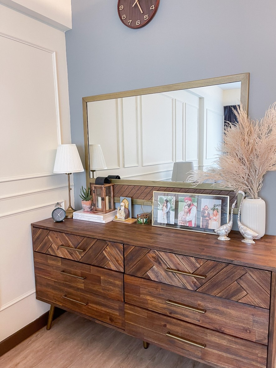 Sleek harmony in our living room - Wooden dresser with geometric herringbone pattern, gold handles, wooden legs, wooden