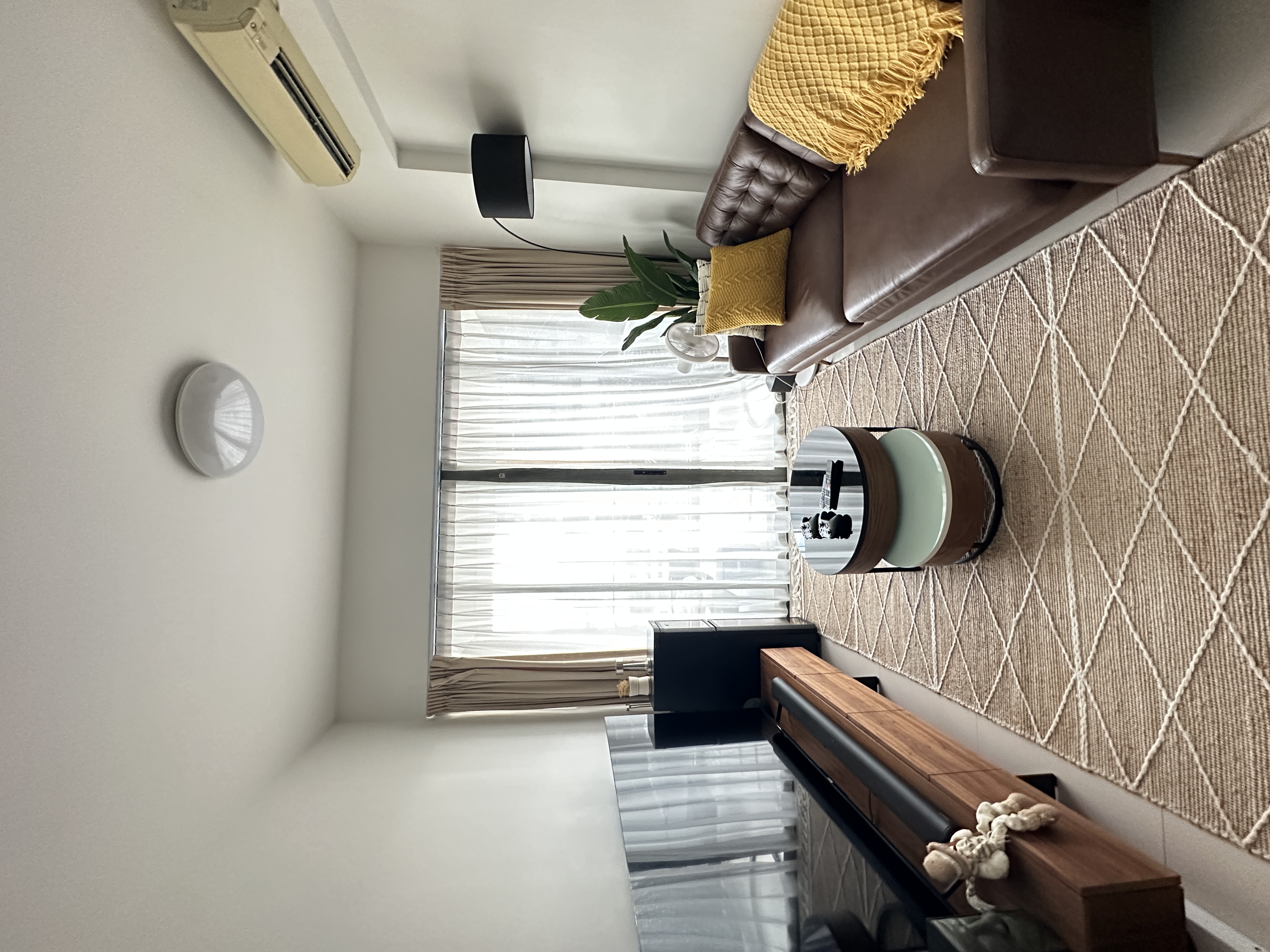 Welcome To Our Mid-Century Modern Condominium - Modern living room with brown leather sofa, yellow throw pillows, beige