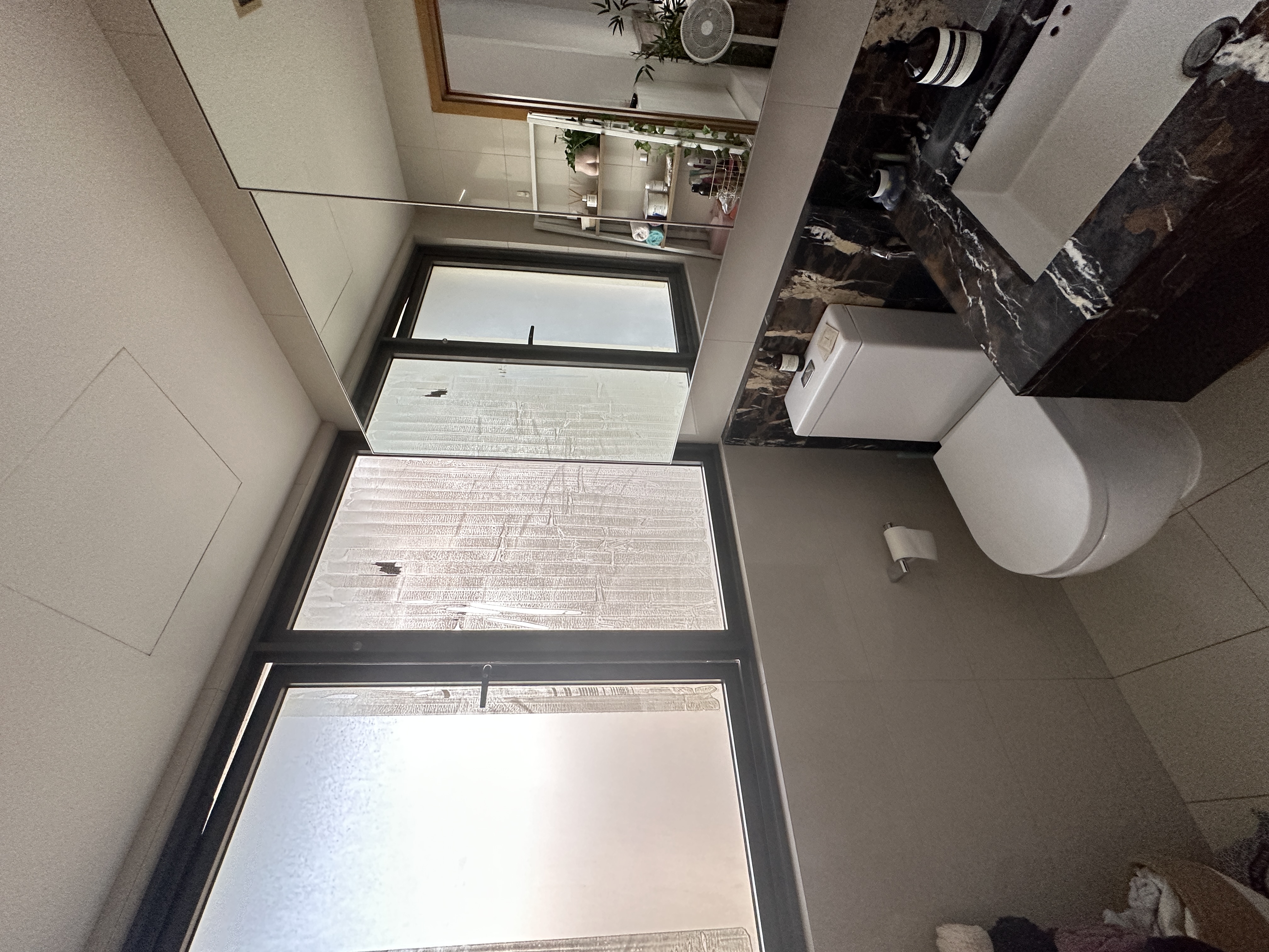 Welcome To Our Mid-Century Modern Condominium - Modern bathroom, large windows, frosted glass, white toilet, marble