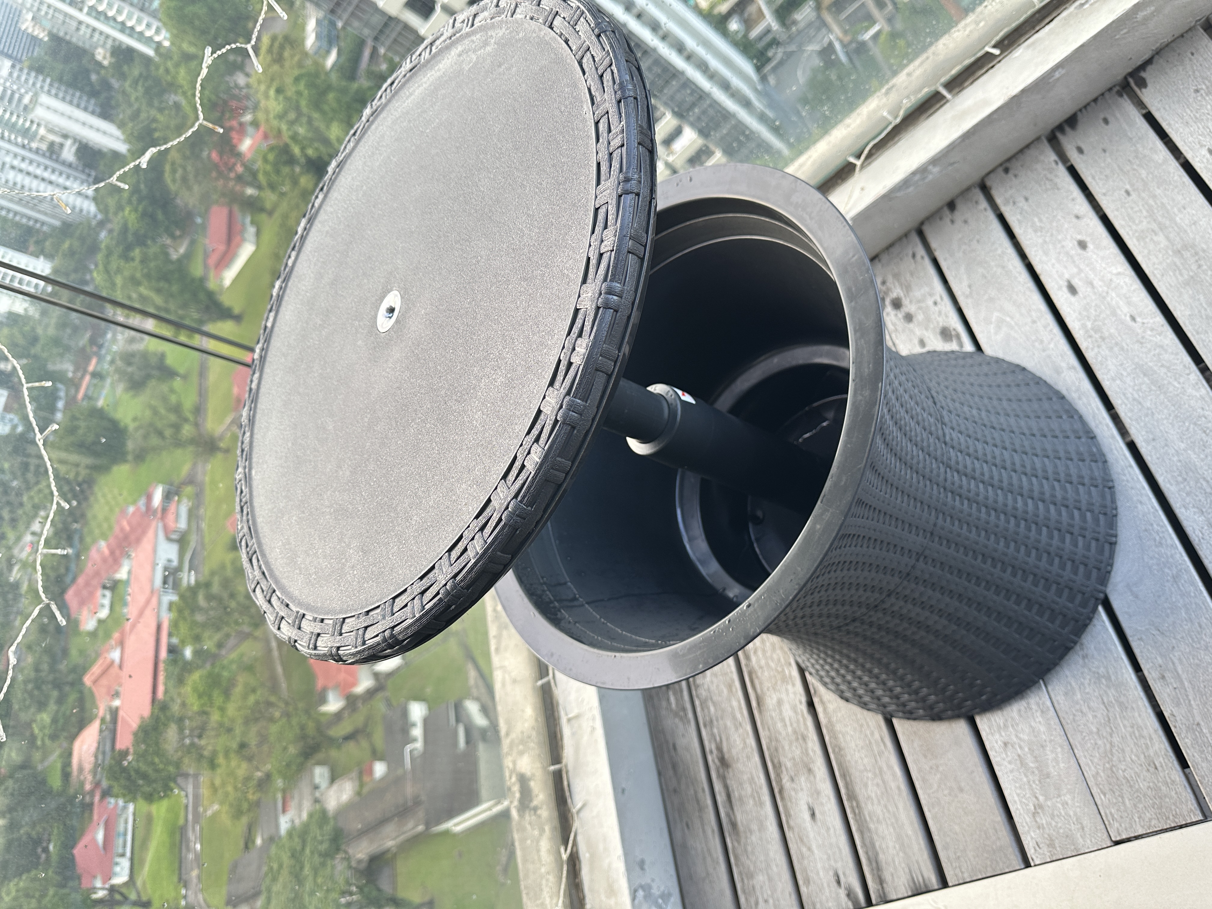 Welcome To Our Mid-Century Modern Condominium - Circular rooftop table with woven texture, Wooden deck overlooking urban