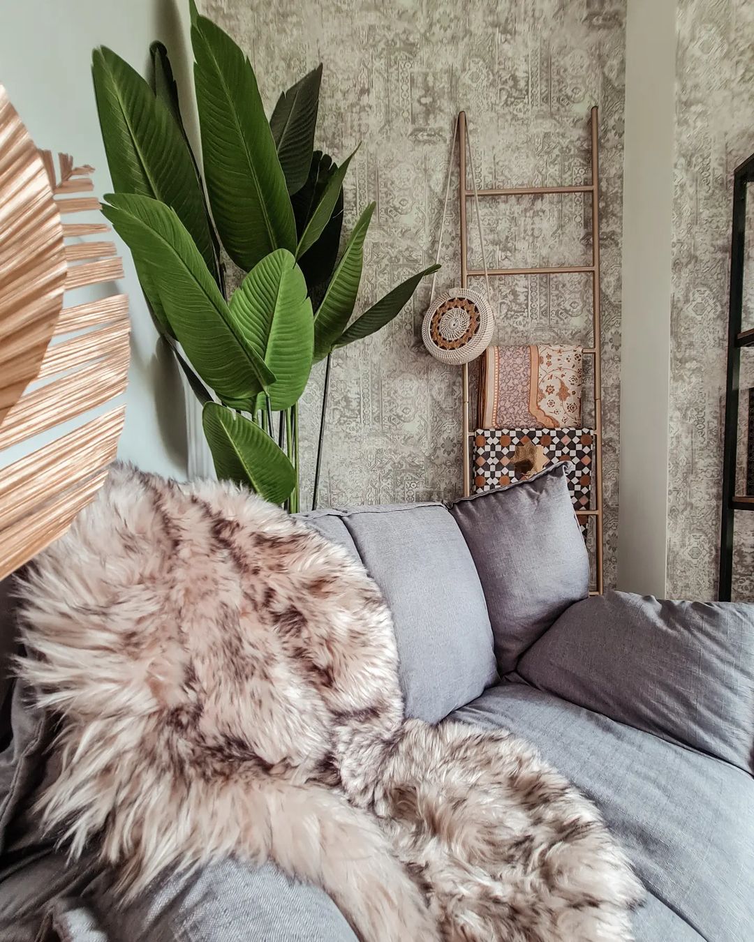 Urban Jungle Chic Cosy Corner! - Faux fur throw blanket, gray sofa, patterned wallpaper, large green plant, woven basket