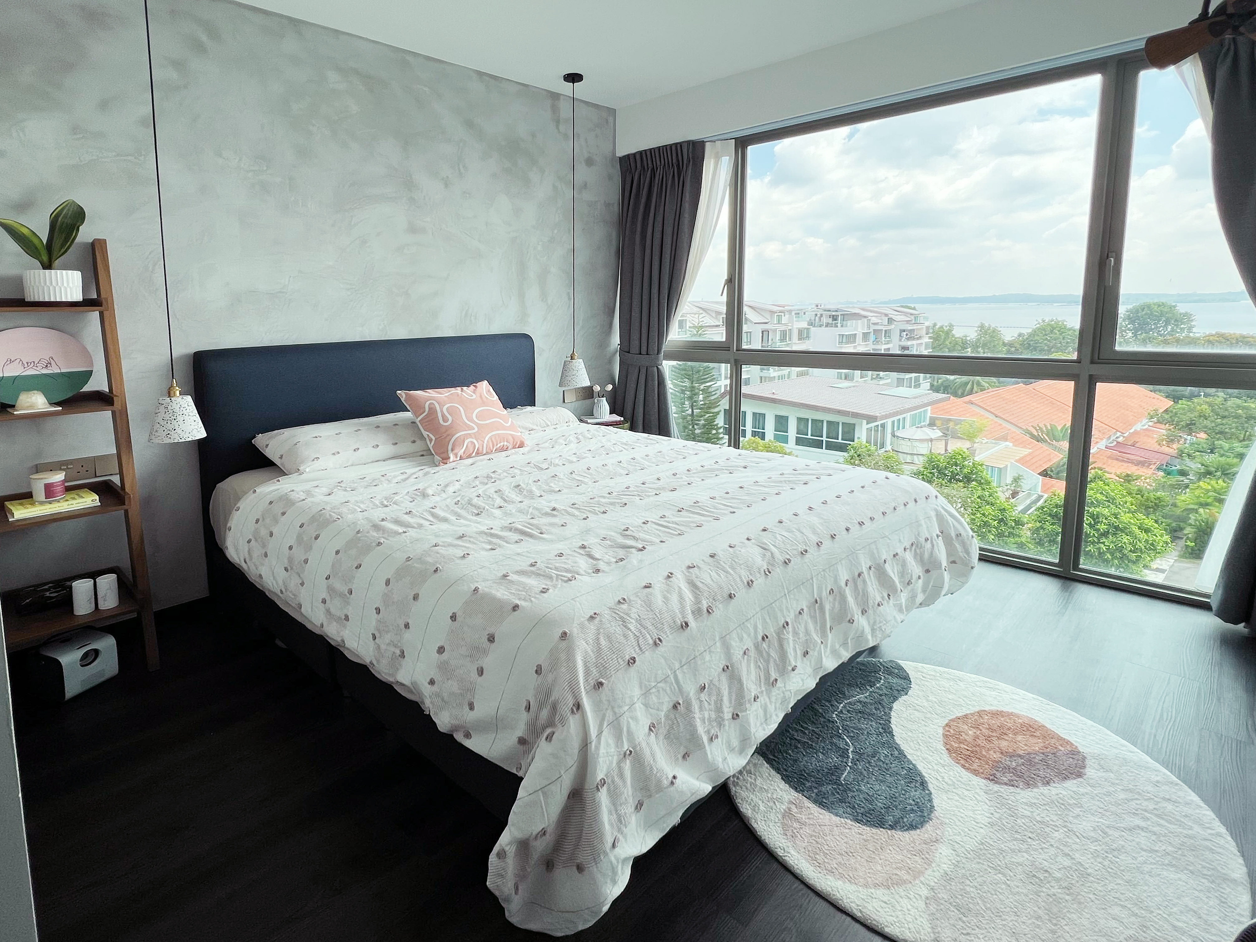 Modern Serenity Bedroom With A View! - Modern bedroom with large window, cozy bed with patterned bedspread, soft lighting