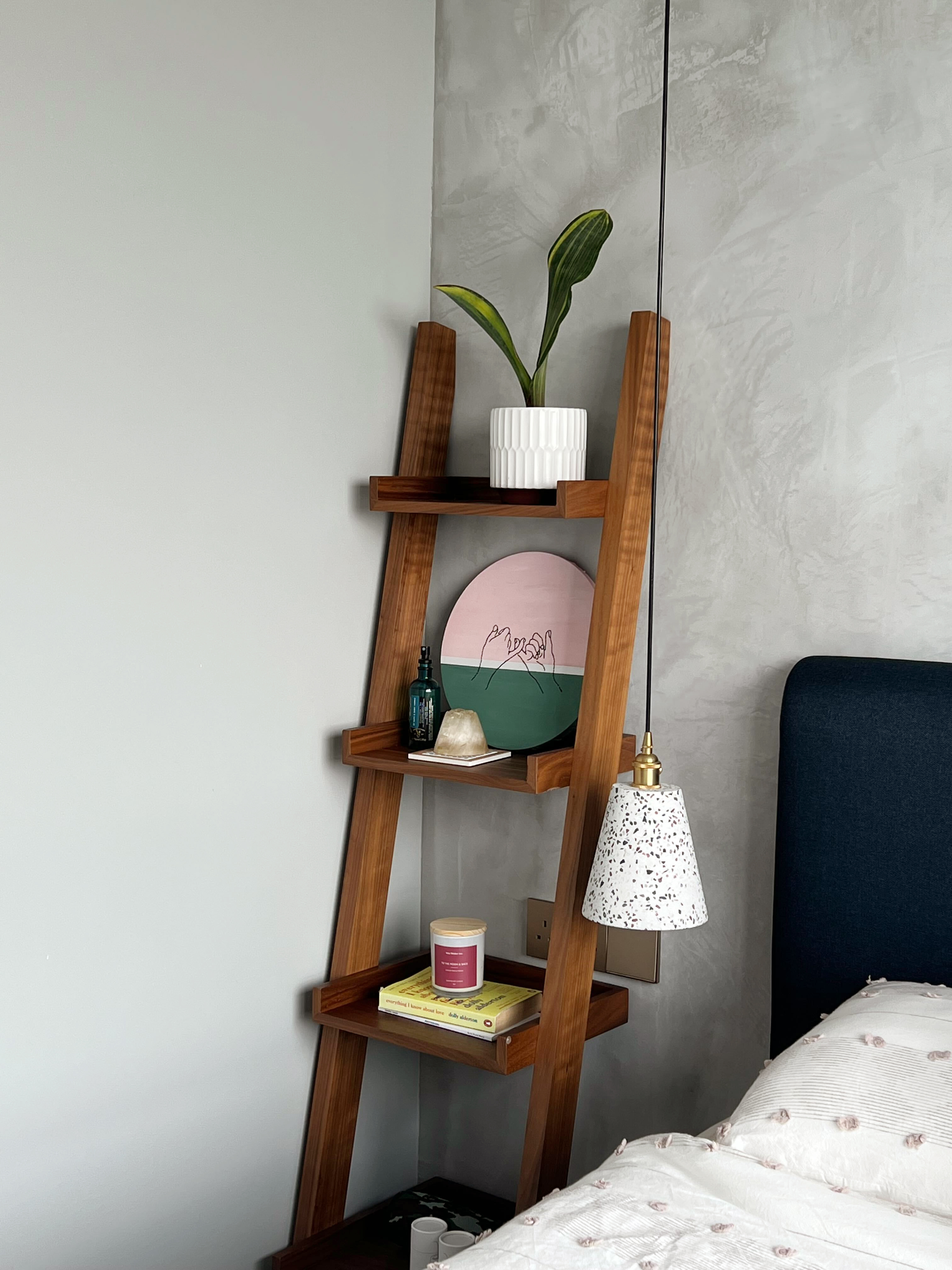 Modern Serenity Bedroom With A View! - Wooden ladder shelf, green potted plant, pink and green plate, white candle, book