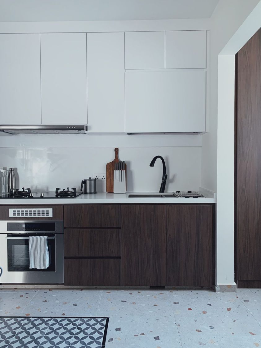 Dark woody tones made better with natural light 🏠 - Modern kitchen with sleek white cabinets, stainless steel range hood