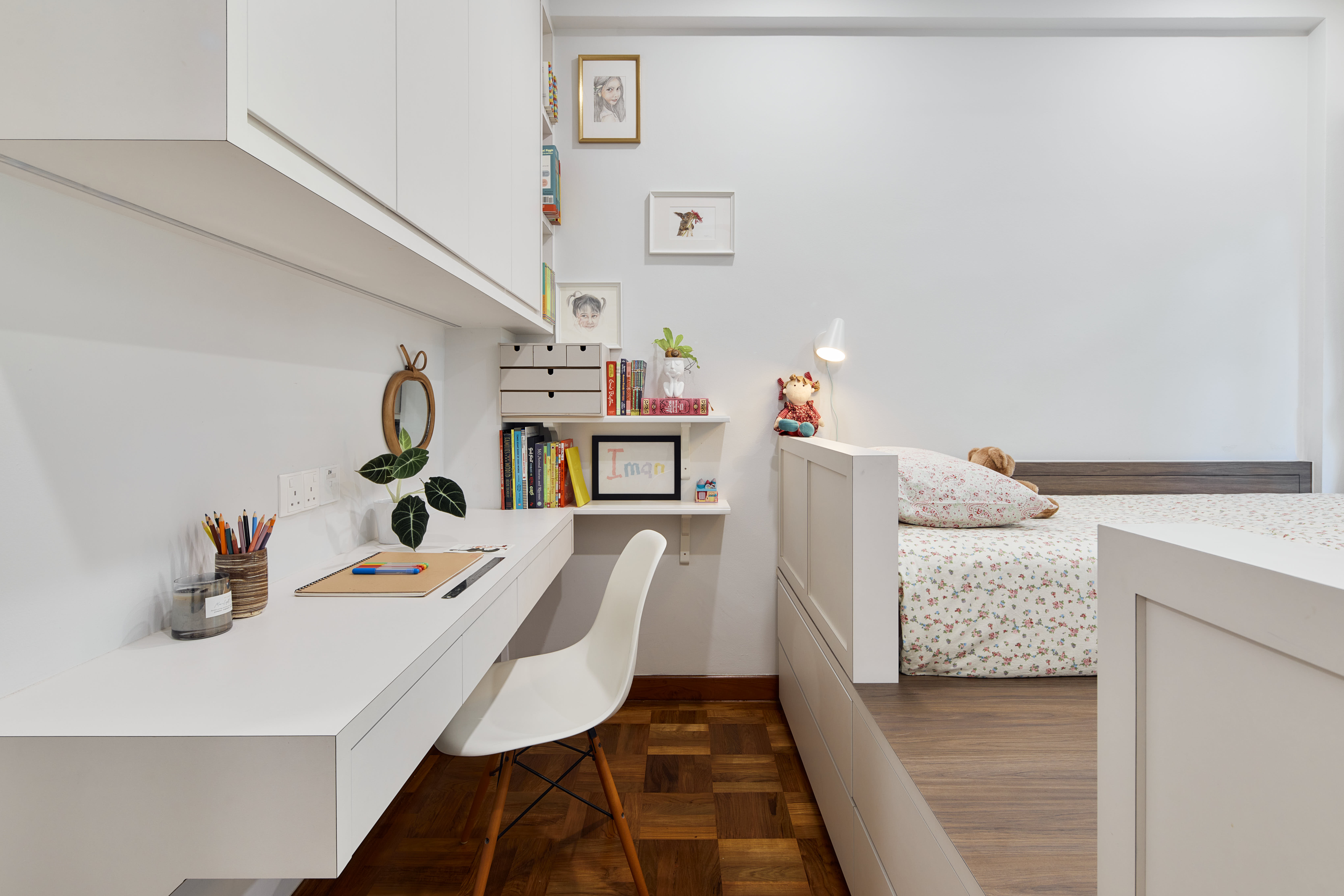 Tranquil Modernity with Rich Wood Flooring - White modern bedroom with built-in shelves, white desk with stationery, white