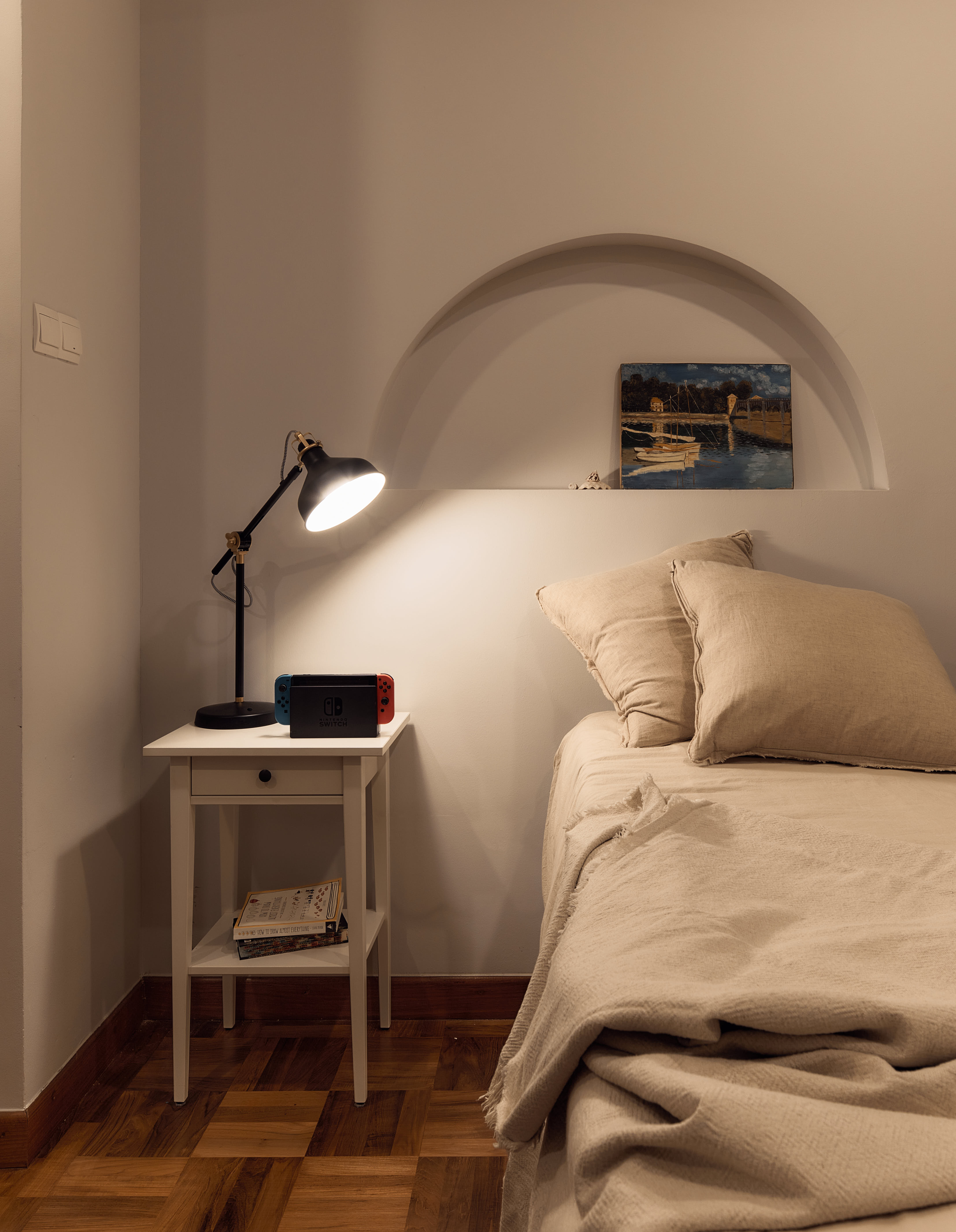 Tranquil Modernity with Rich Wood Flooring - Modern bedroom, cozy corner, bedside table, white nightstand, black lamp