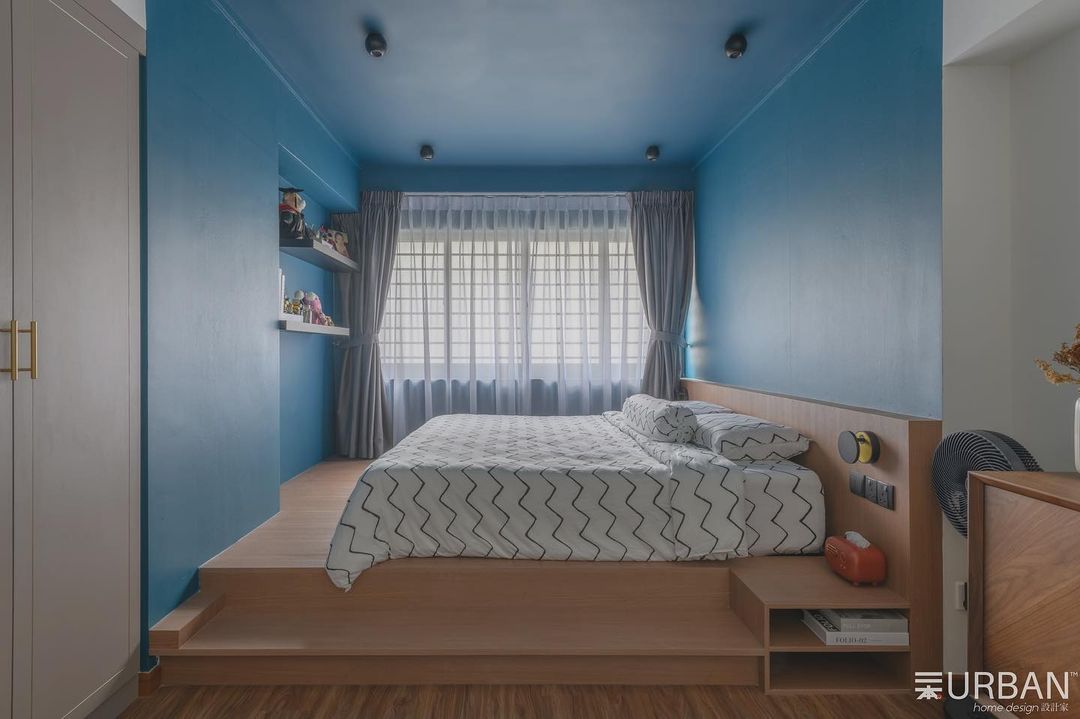 Blue Bliss Bedroom - Blue painted walls, modern design, wooden bed frame, white and gray bedding, built-in shelf, window with