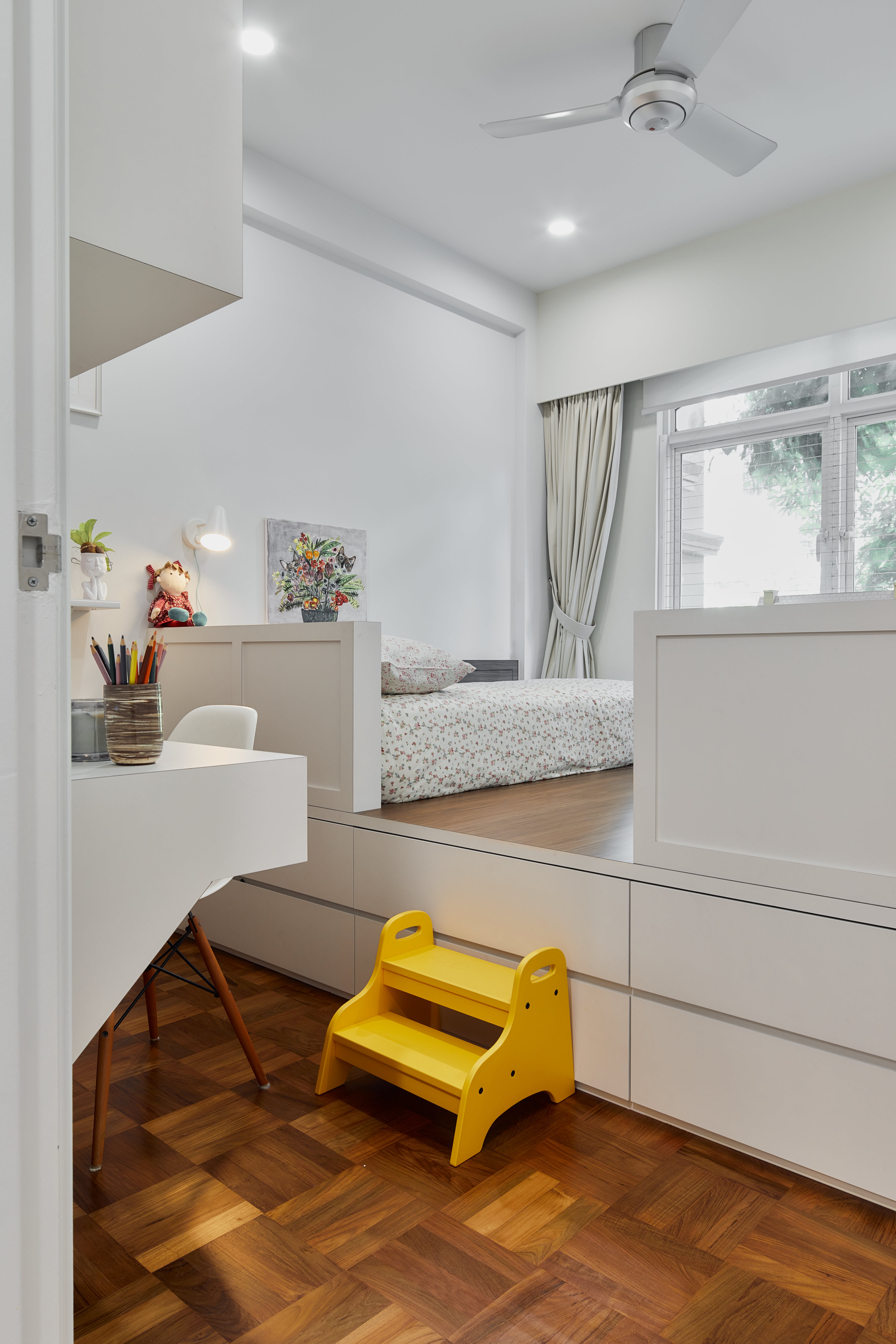 Tranquil Modernity with Rich Wood Flooring - White bedroom with modern design, wooden floor, ceiling fan, white desk with