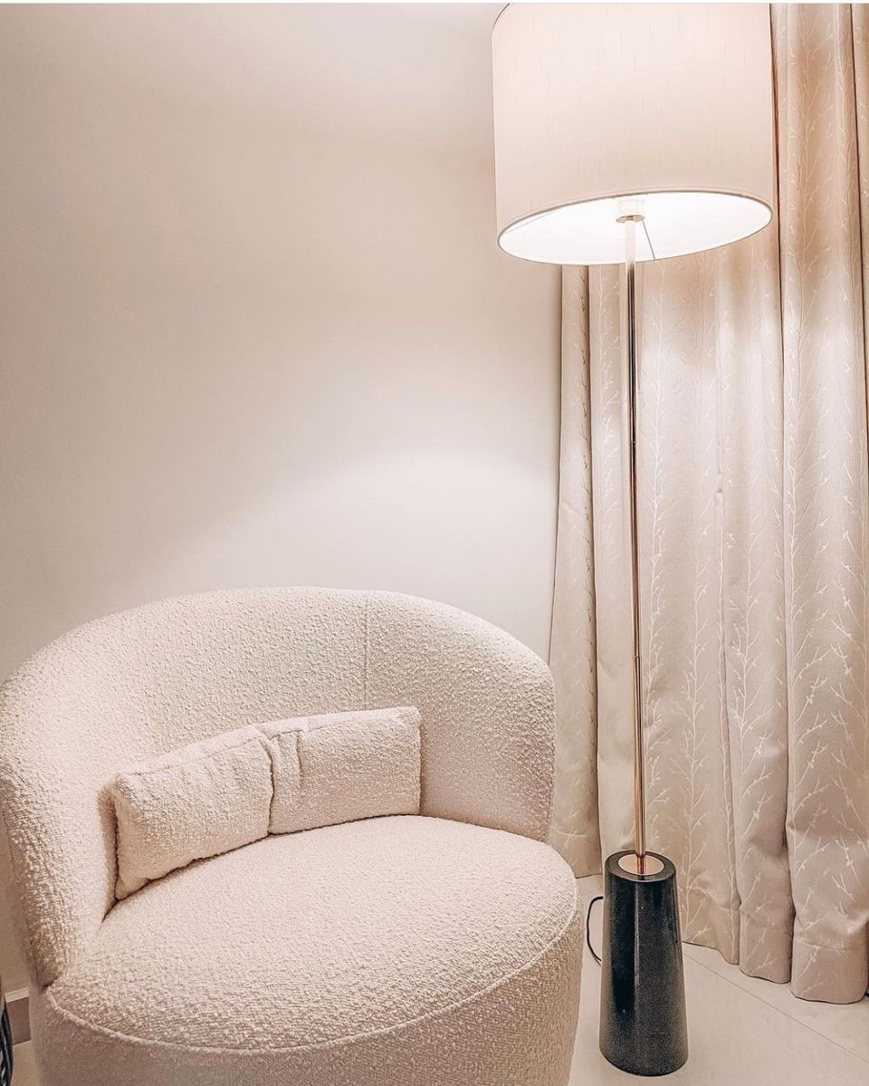 Elegance in Our Simple Cosy Corner - Cream-colored, plush armchair, soft lighting, modern decor, cozy ambiance, elegant