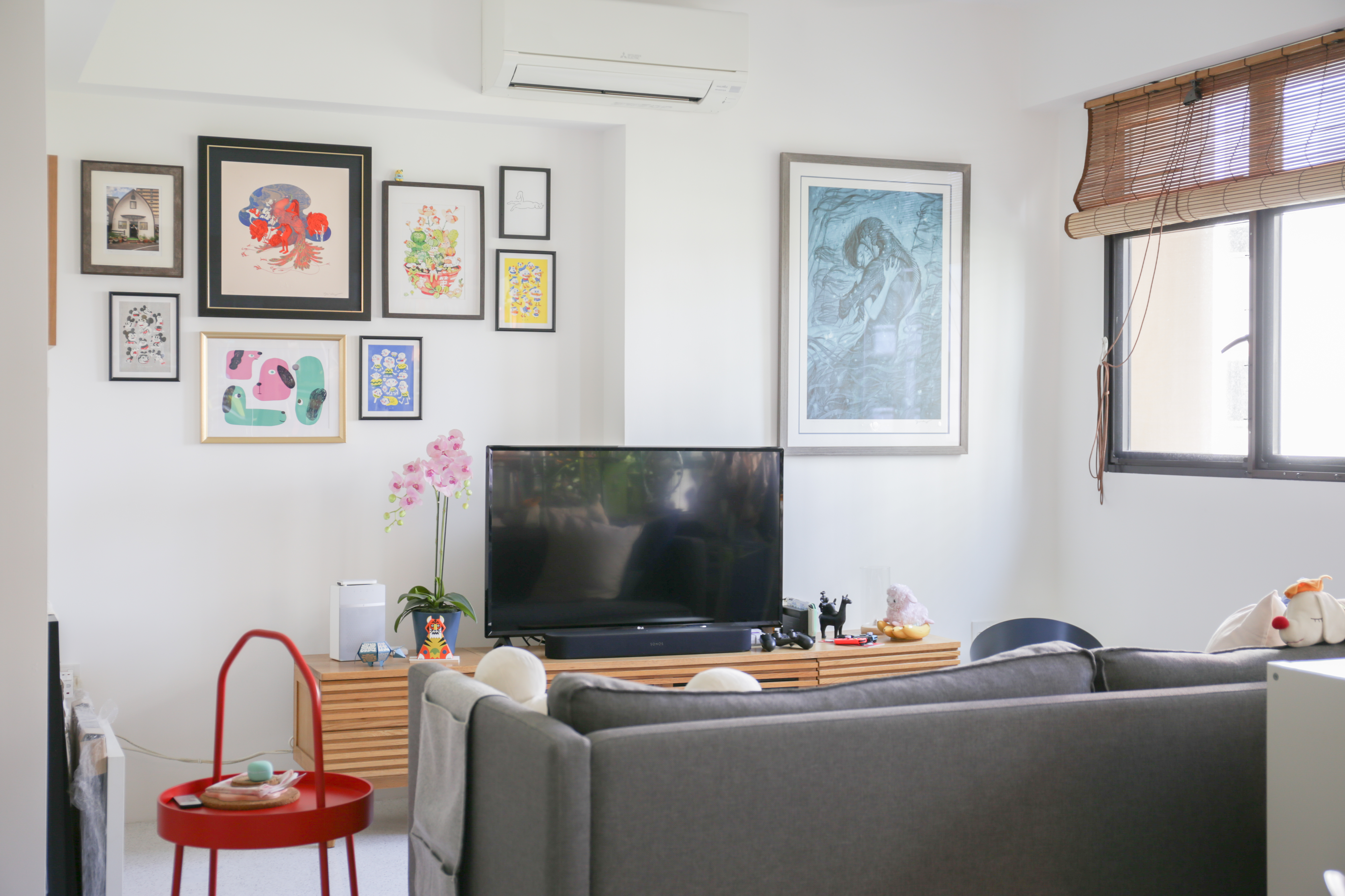 The Eccentricity of an Artistic Couple’s Apartment - Framed artwork, white wall, modern decor, colorful abstract painting