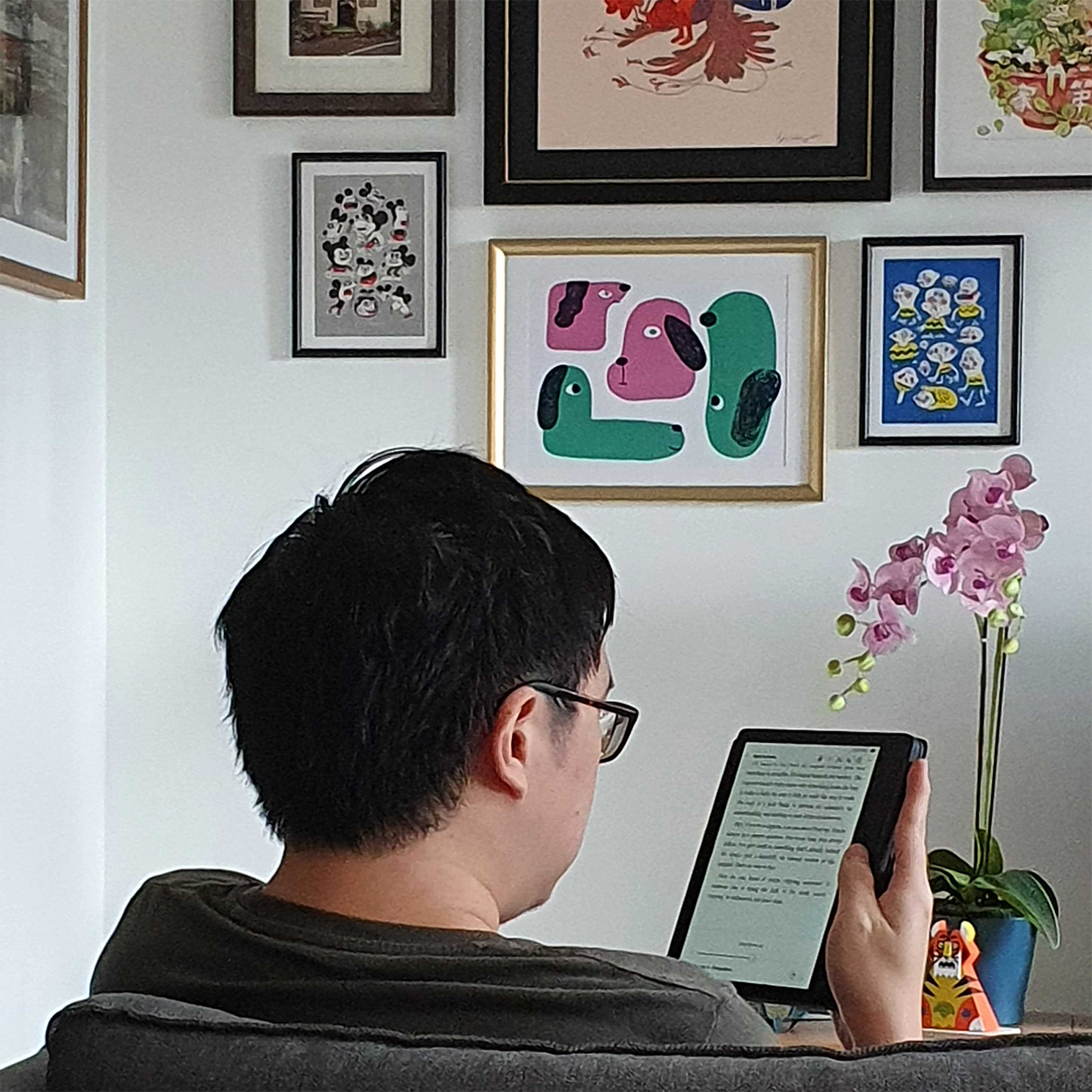 The Eccentricity of an Artistic Couple’s Apartment - Framed artwork, colorful abstract art, minimalist decor, person reading