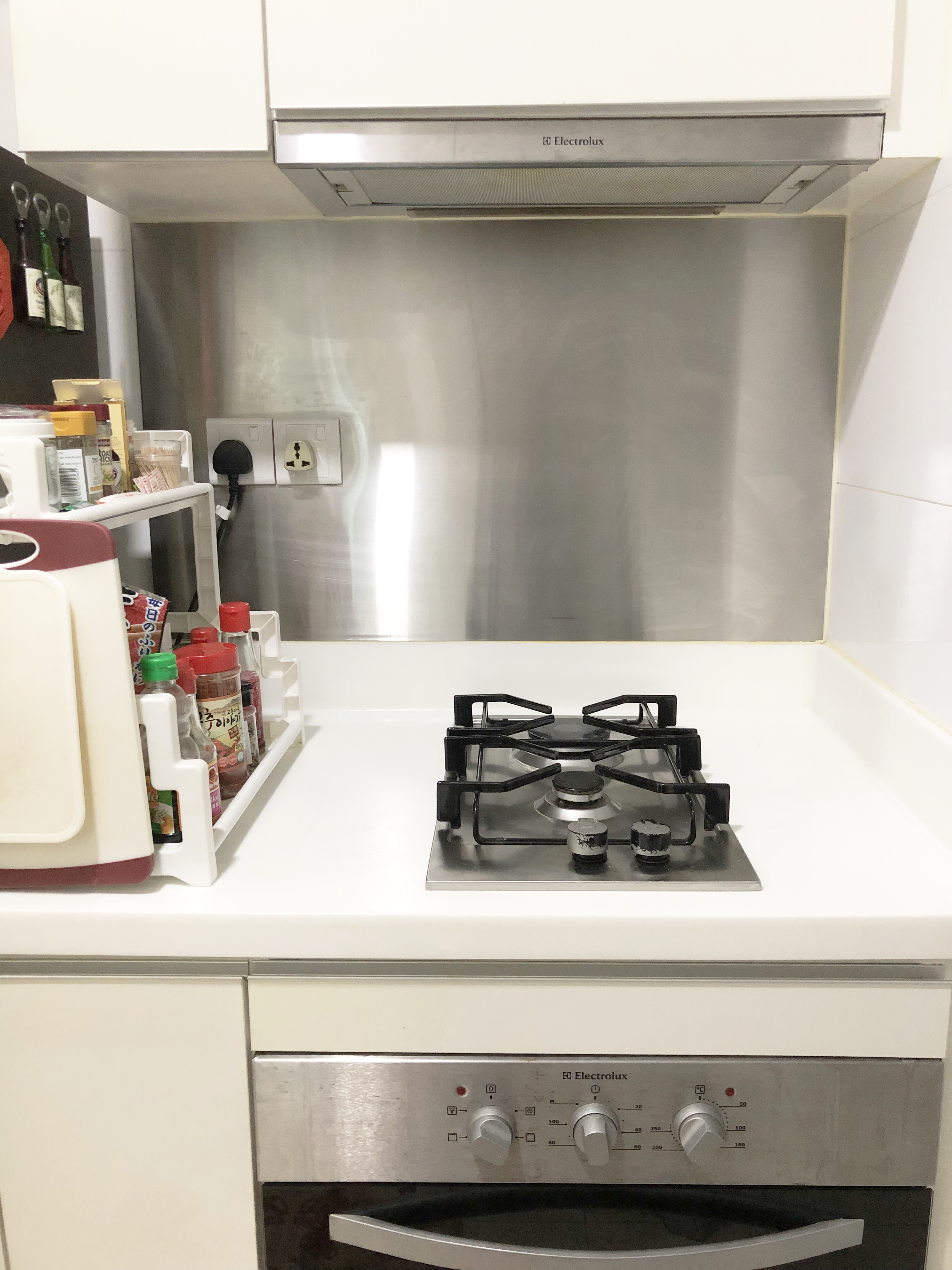 My Home Away From Home - Kitchen countertop, stainless steel backsplash, gas stove, white cabinets, electric range, black