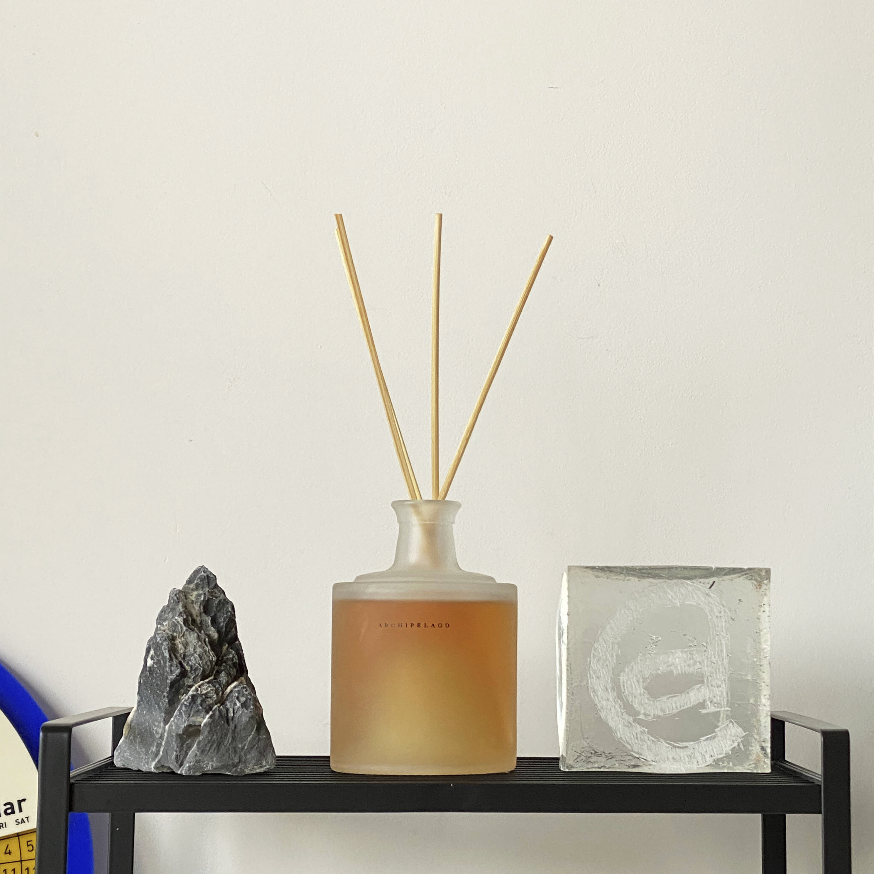 A Photographer's One-Room Studio Man Cave - vase with wooden sticks, mineral collection, amber liquid, crystal container