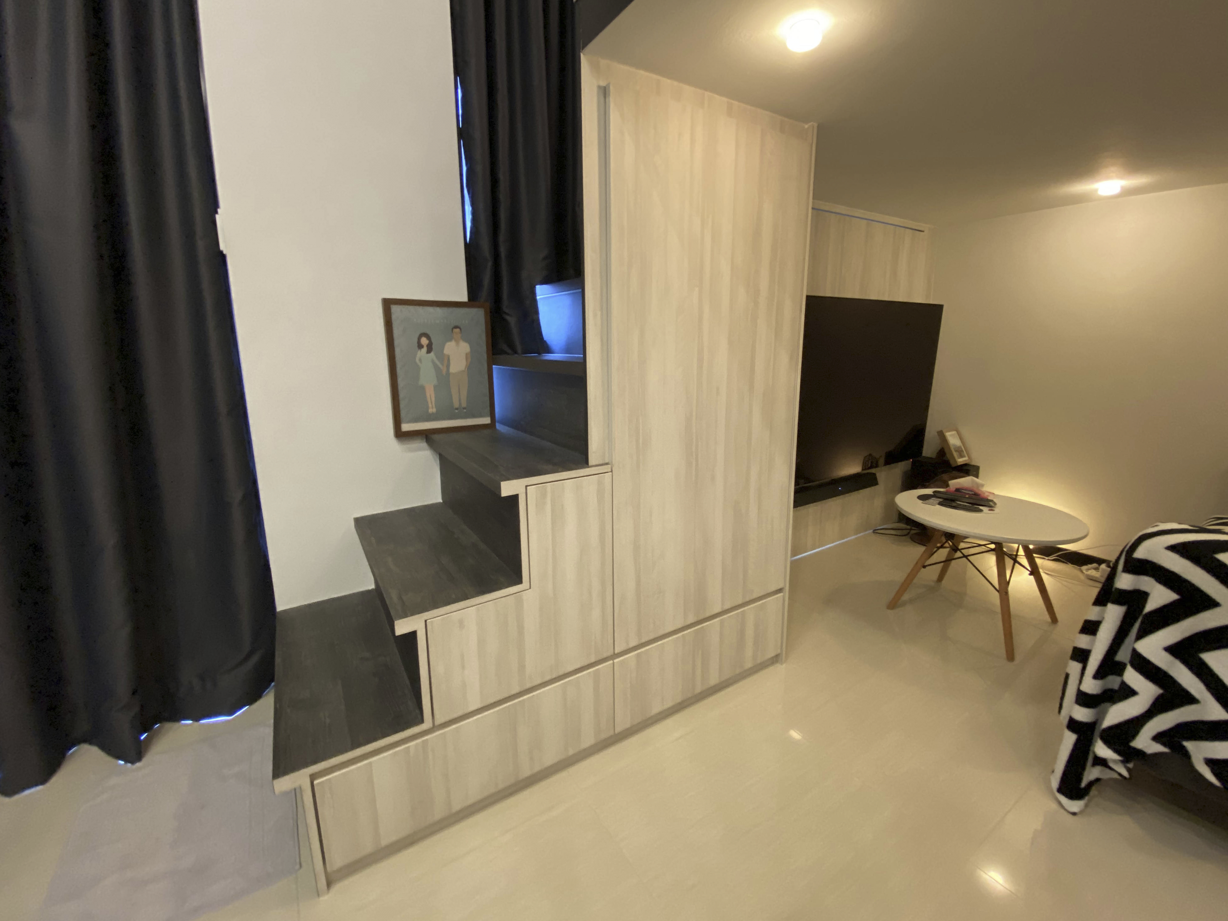 Our Smart Apartment That Might Be Smarter Than Us - Wooden wardrobe with black shelves, framed picture of a couple, black