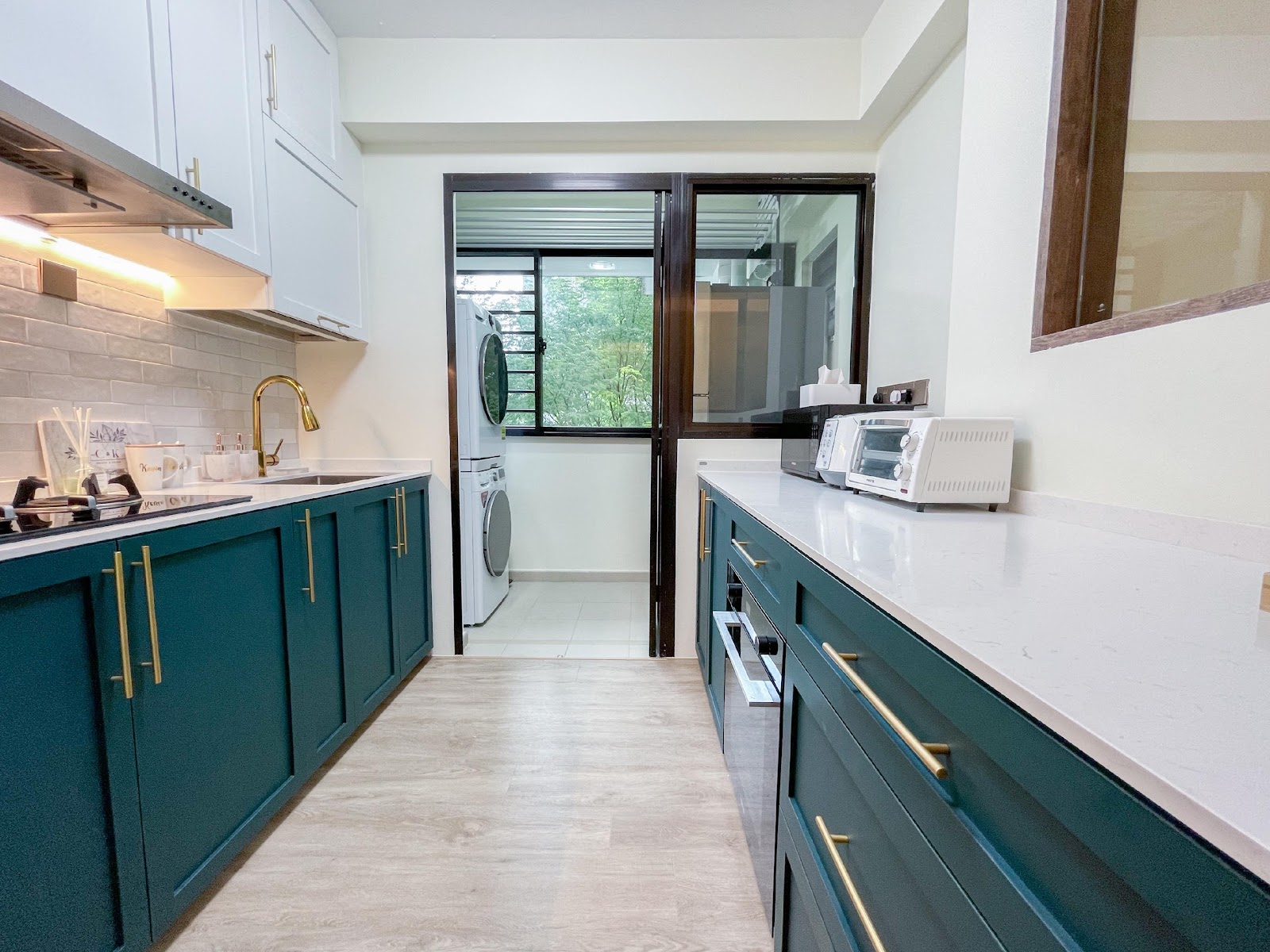 Modern Home for the Modern Interracial Couple - Modern kitchen with teal cabinets and gold handles, stainless steel range