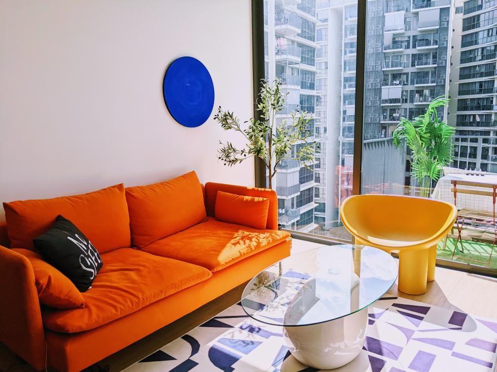 Bright colours are my jam - Orange sofa, vibrant decor, modern design, large window, city view, indoor garden, plant