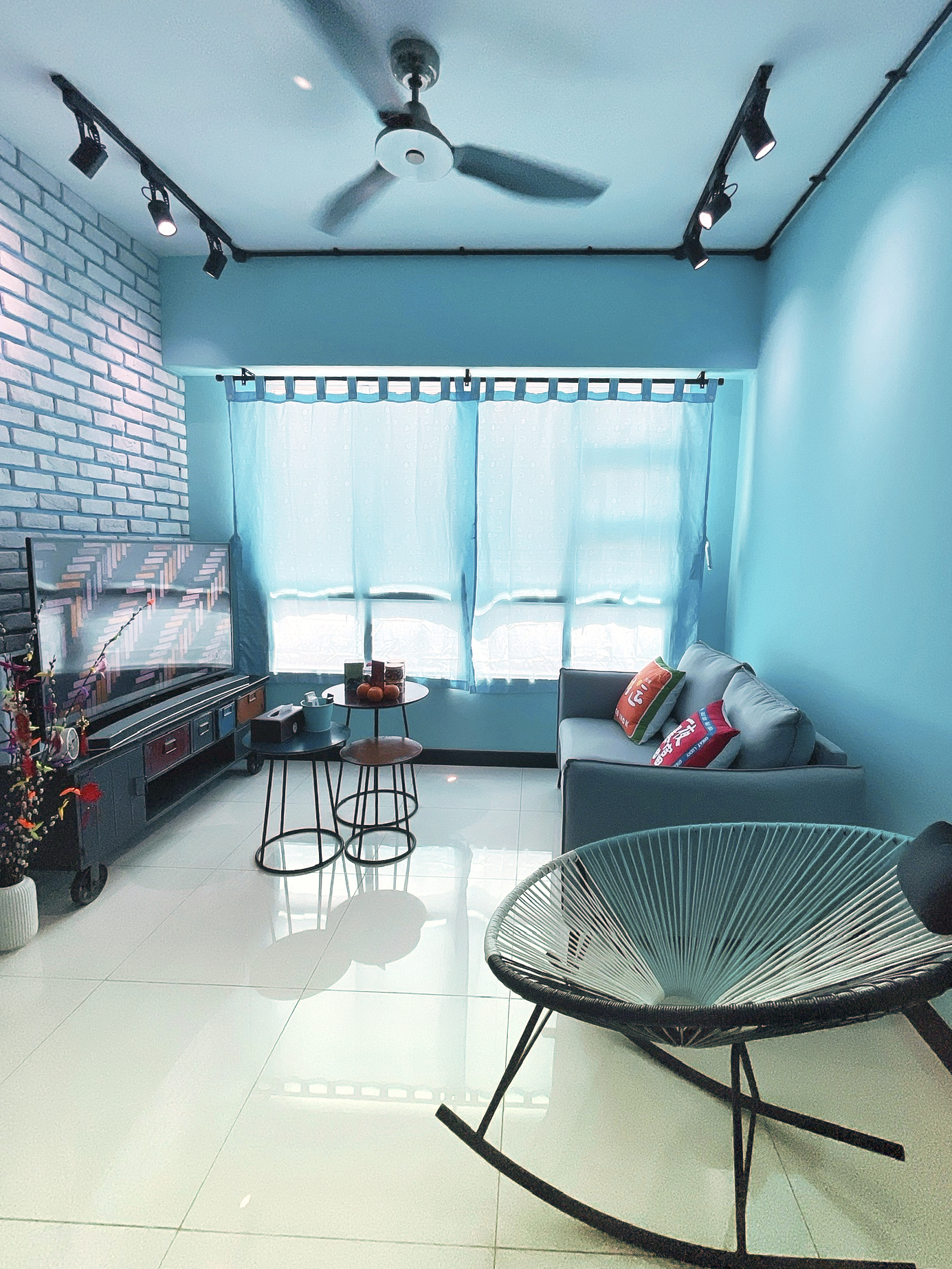 Our Colourful Personalities Imprinted On Our Apartment - Blue-lit living room, modern furniture, white brick wall, ceiling