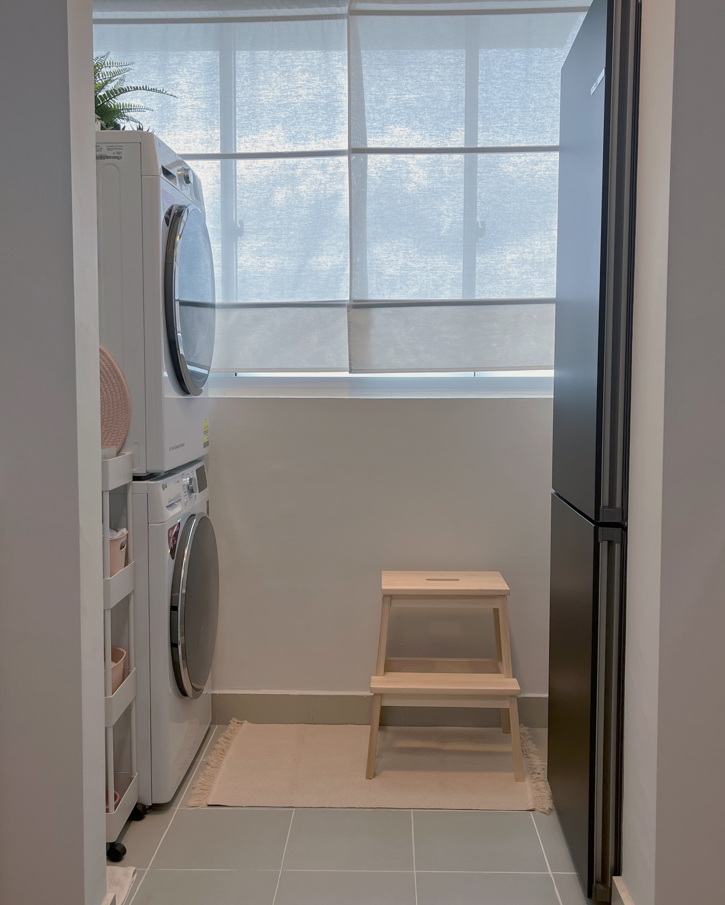 Living In A Cosy 3-room Flat with Minimal Housekeeping - Modern laundry room, white washing machine, wooden stool, light gray
