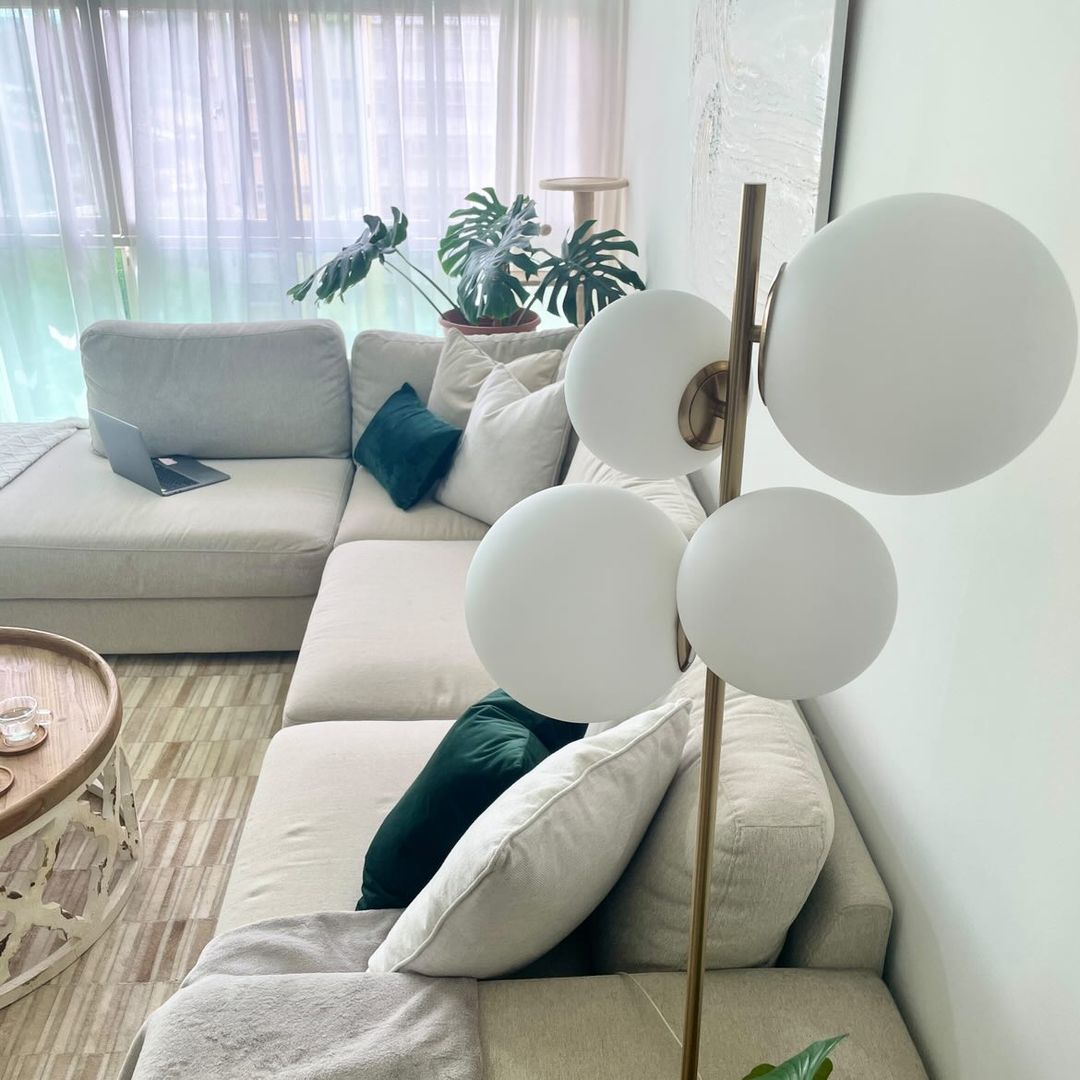 This home is the reflections of our likings - Modern living room, cozy seating, beige sofa, white pillows, laptop on couch