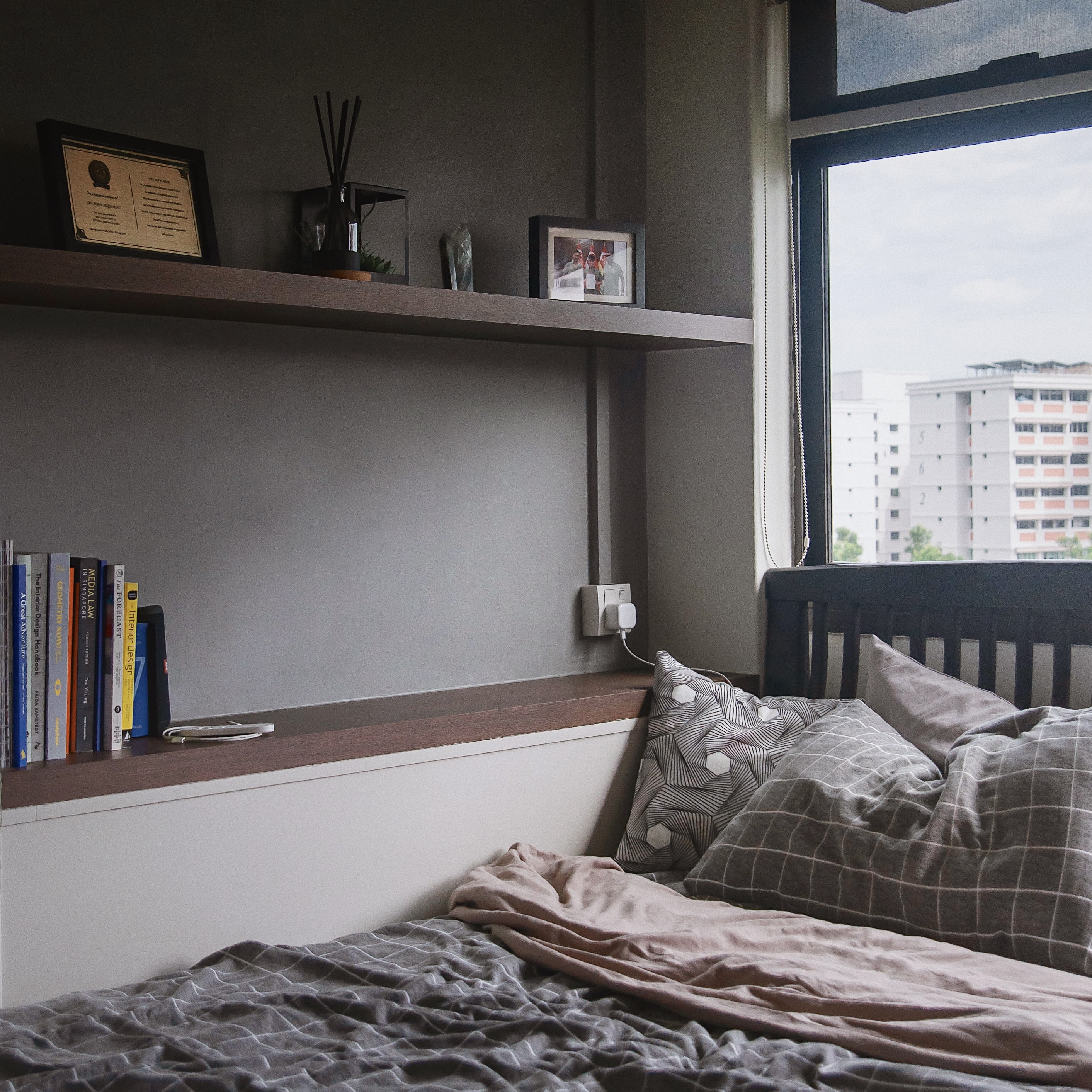 A Graphic Designer’s Humble Abode - Bookshelf, cozy bedroom, modern decor, bookshelf with books, framed certificates, indoor