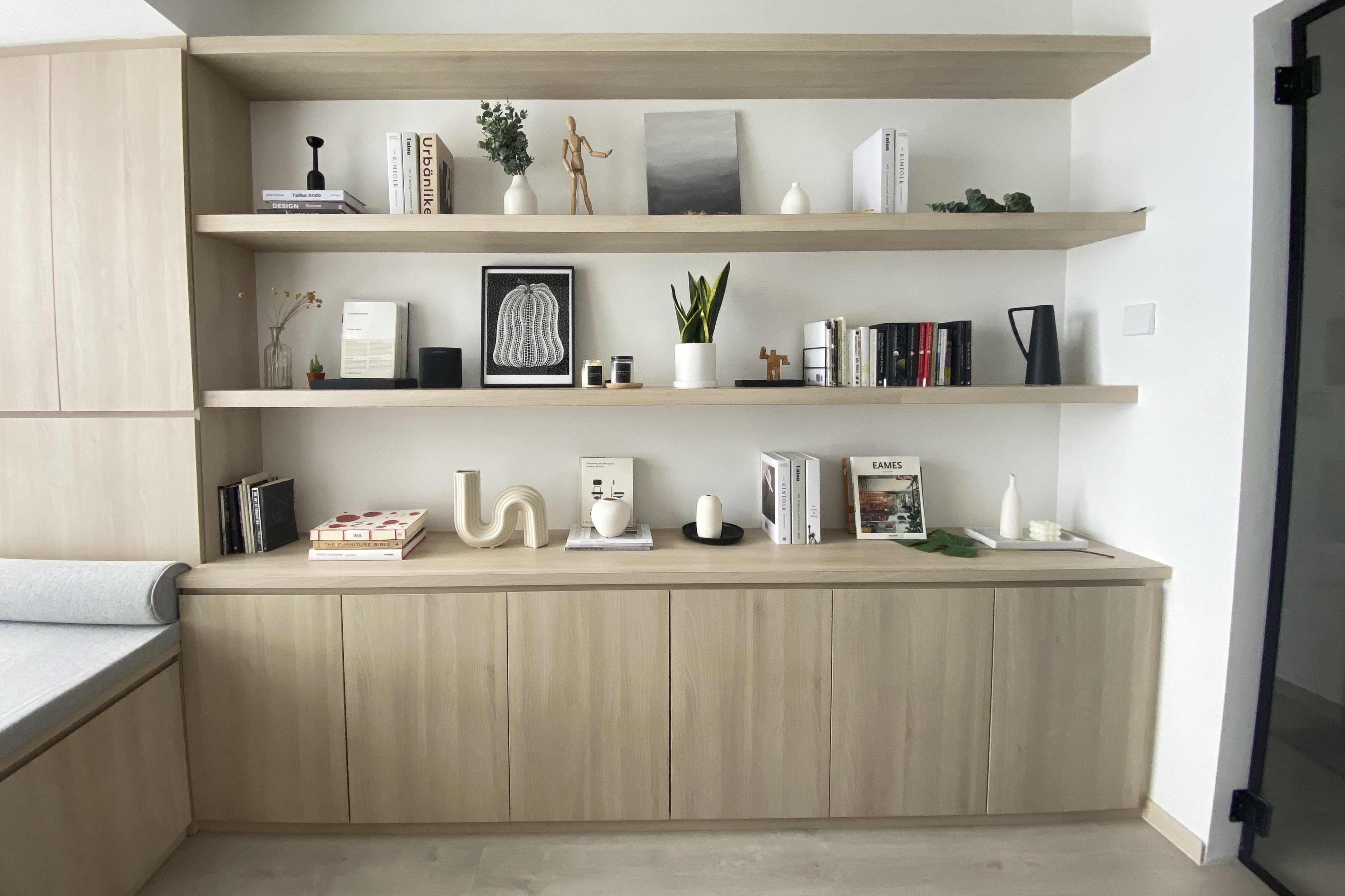 A Minimalist Apartment with an Urban Jungle - Wooden shelves, minimalist design, modern decor, neutral color palette, light
