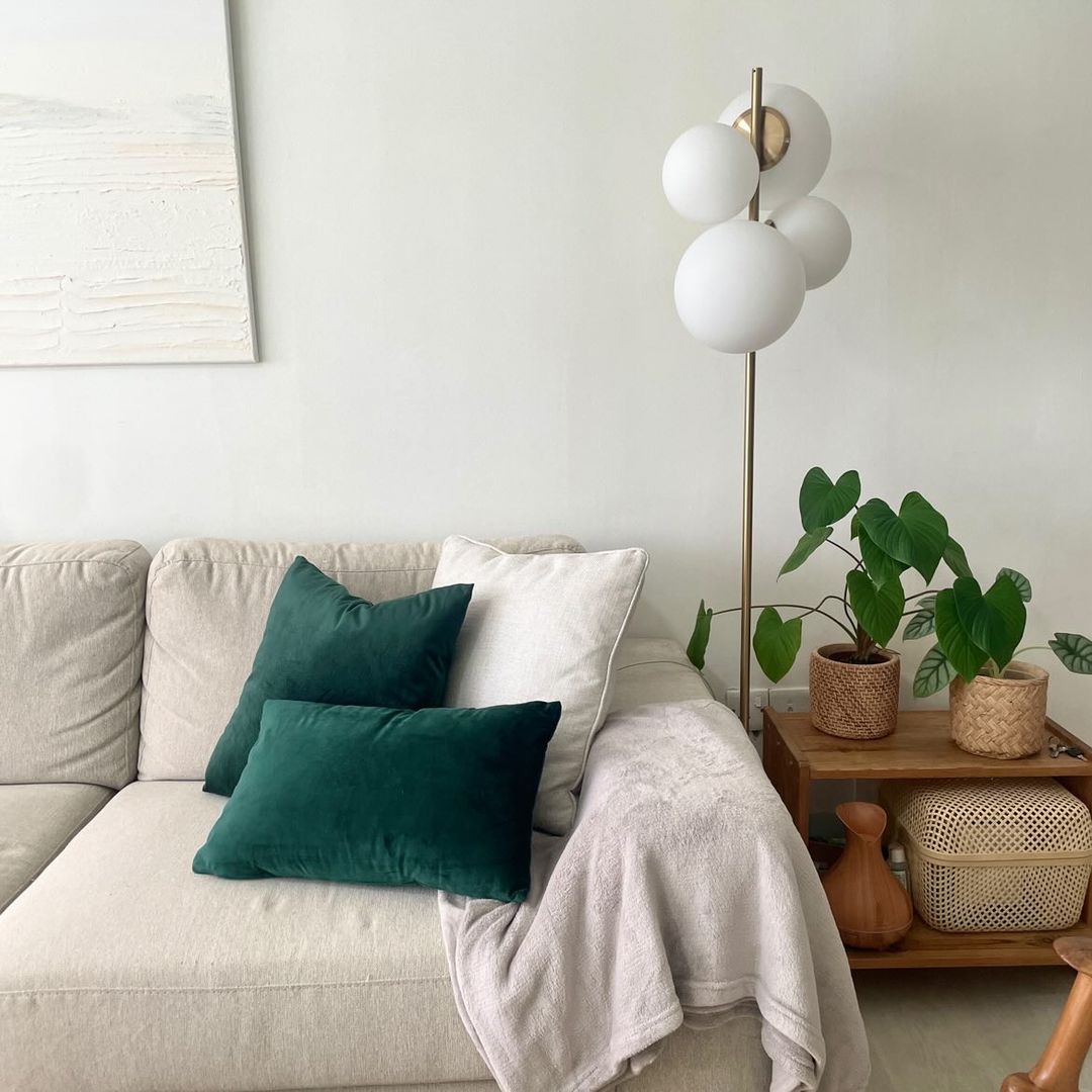 This home is the reflections of our likings - Light-colored sofa with green and white pillows, beige throw blanket