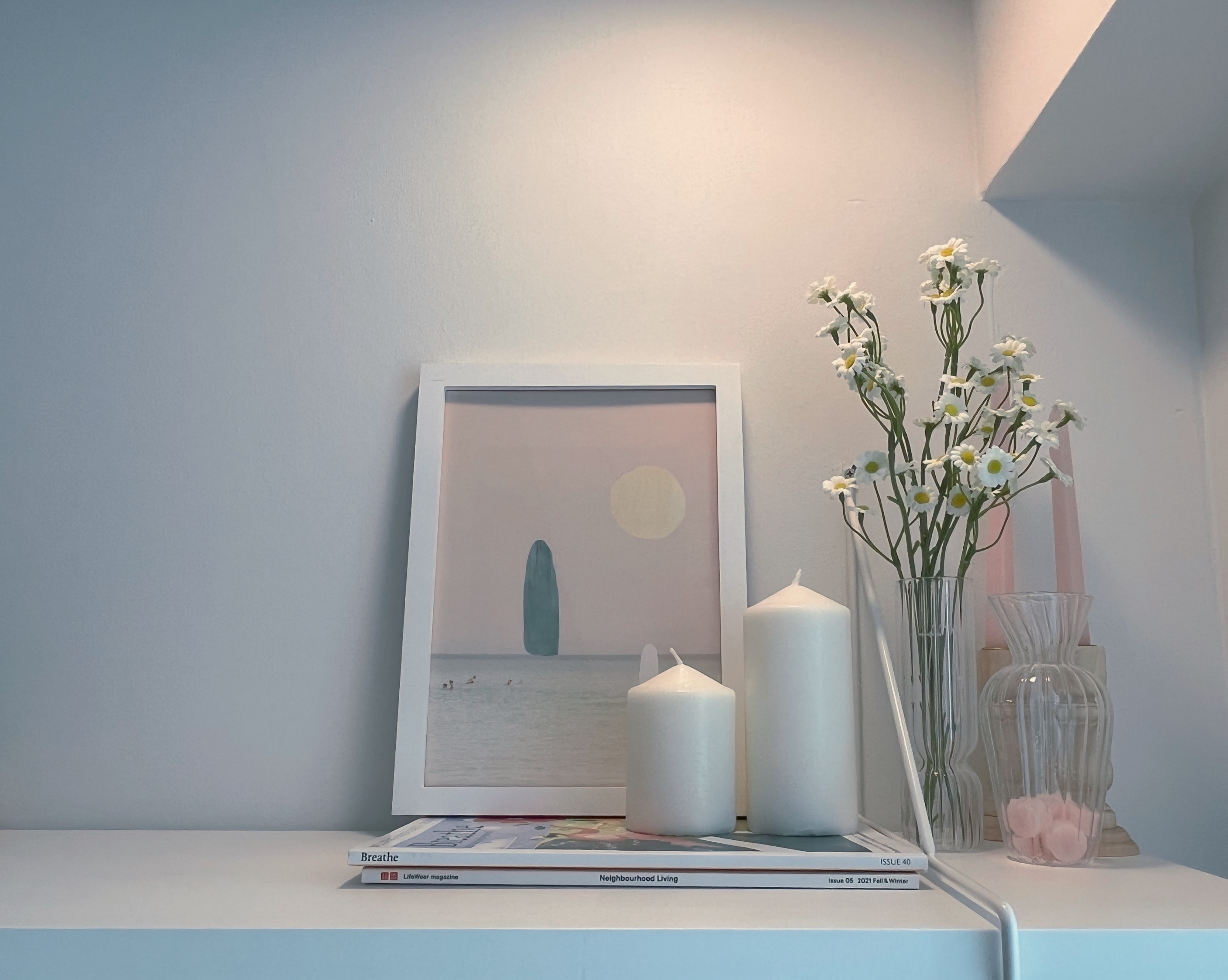 Living In A Cosy 3-room Flat with Minimal Housekeeping - Sunlit wall, minimalist decor, framed picture, pastel colors, white