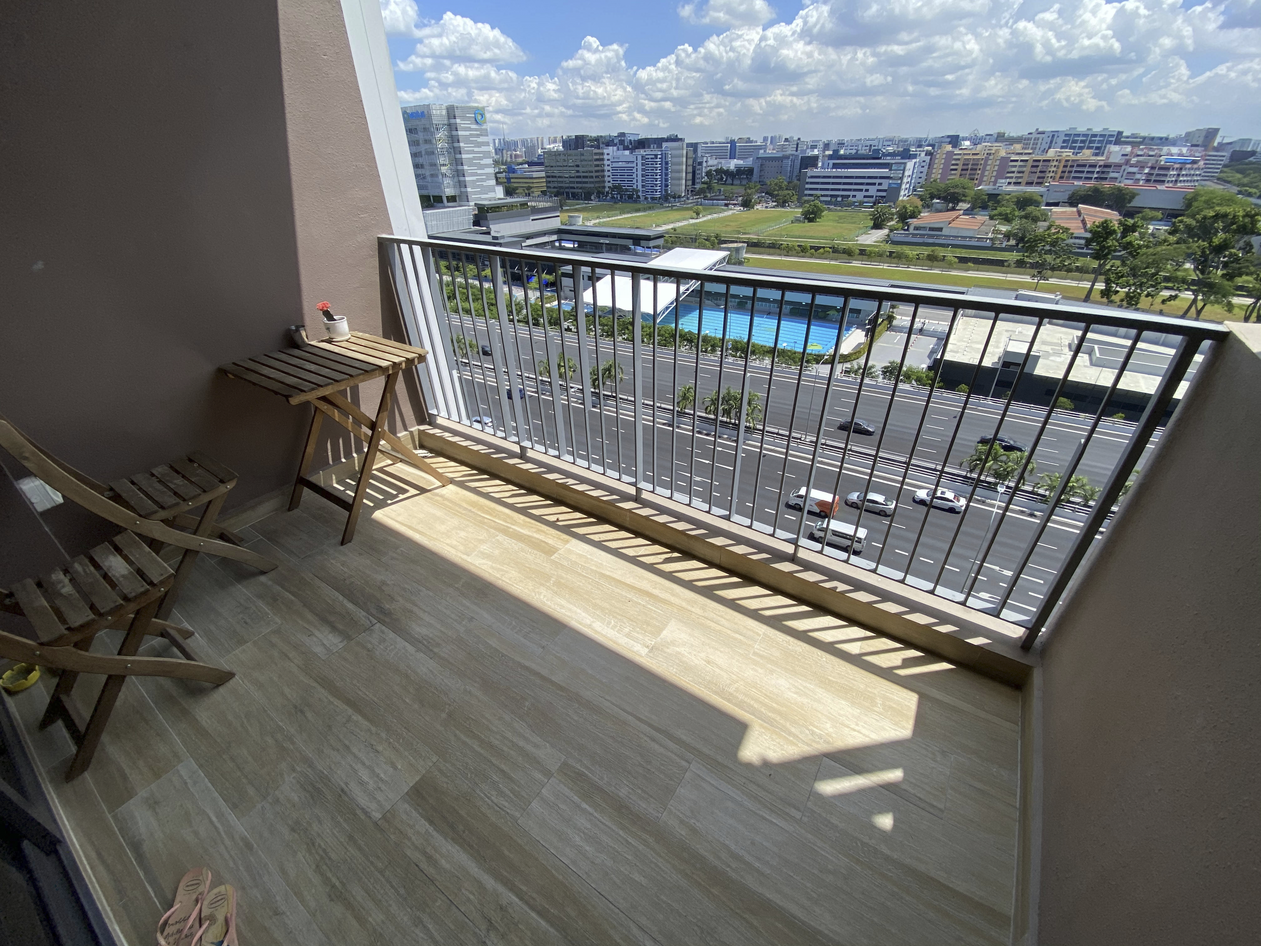 Our Smart Apartment That Might Be Smarter Than Us - Sunlit balcony, modern furniture, wooden chairs, tiled floor, outdoor