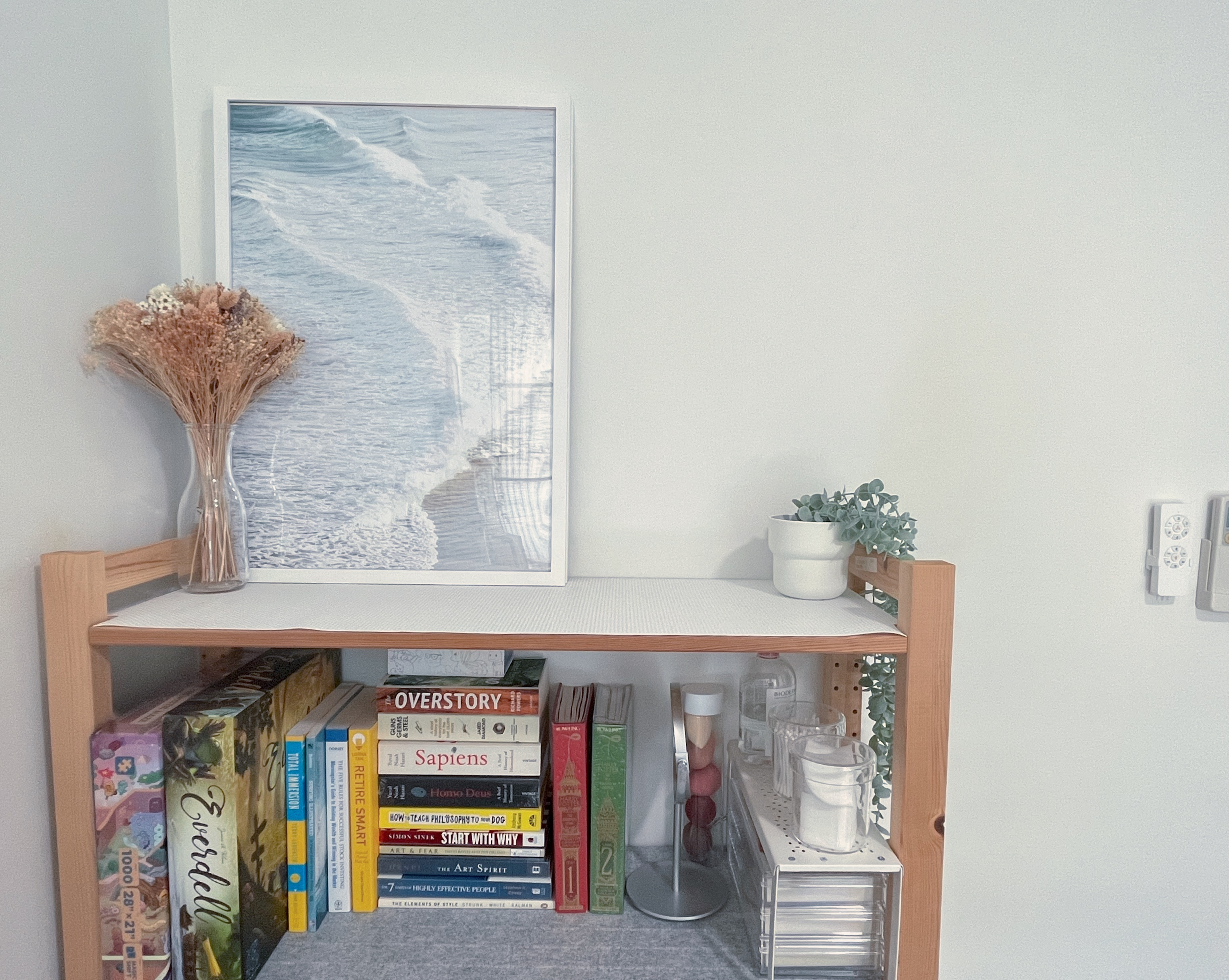 Living In A Cosy 3-room Flat with Minimal Housekeeping - Wooden shelf with a framed ocean wave painting, Clear glass vase