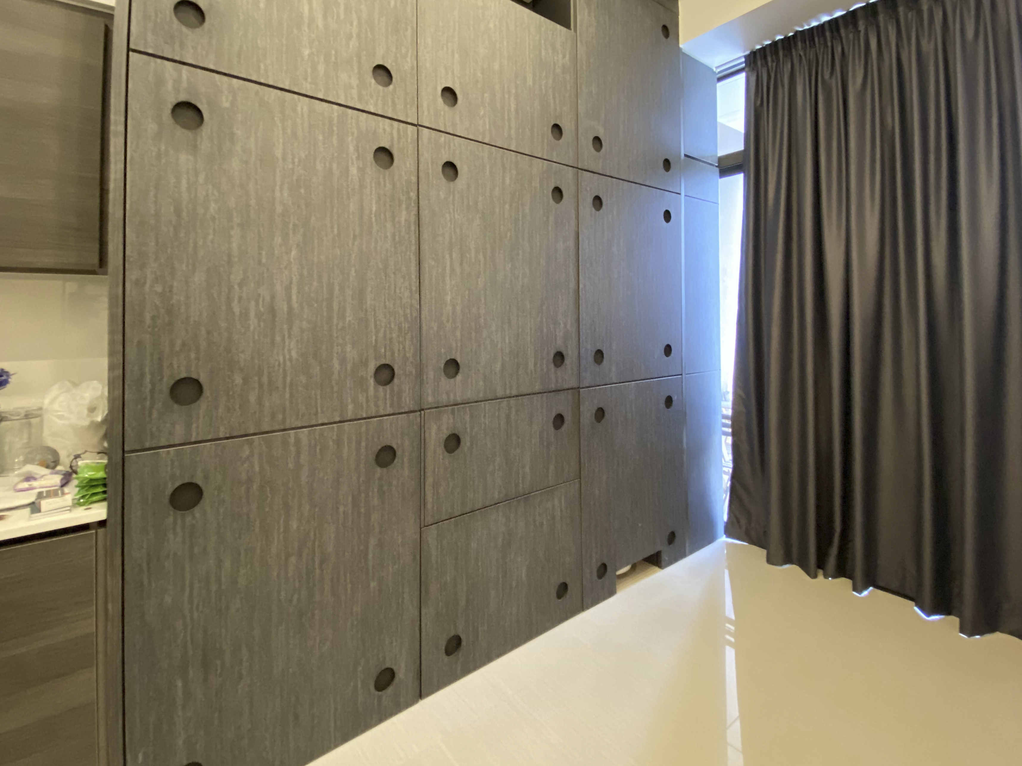 Our Smart Apartment That Might Be Smarter Than Us - Gray textured cabinet with circular holes, modern design, vertical